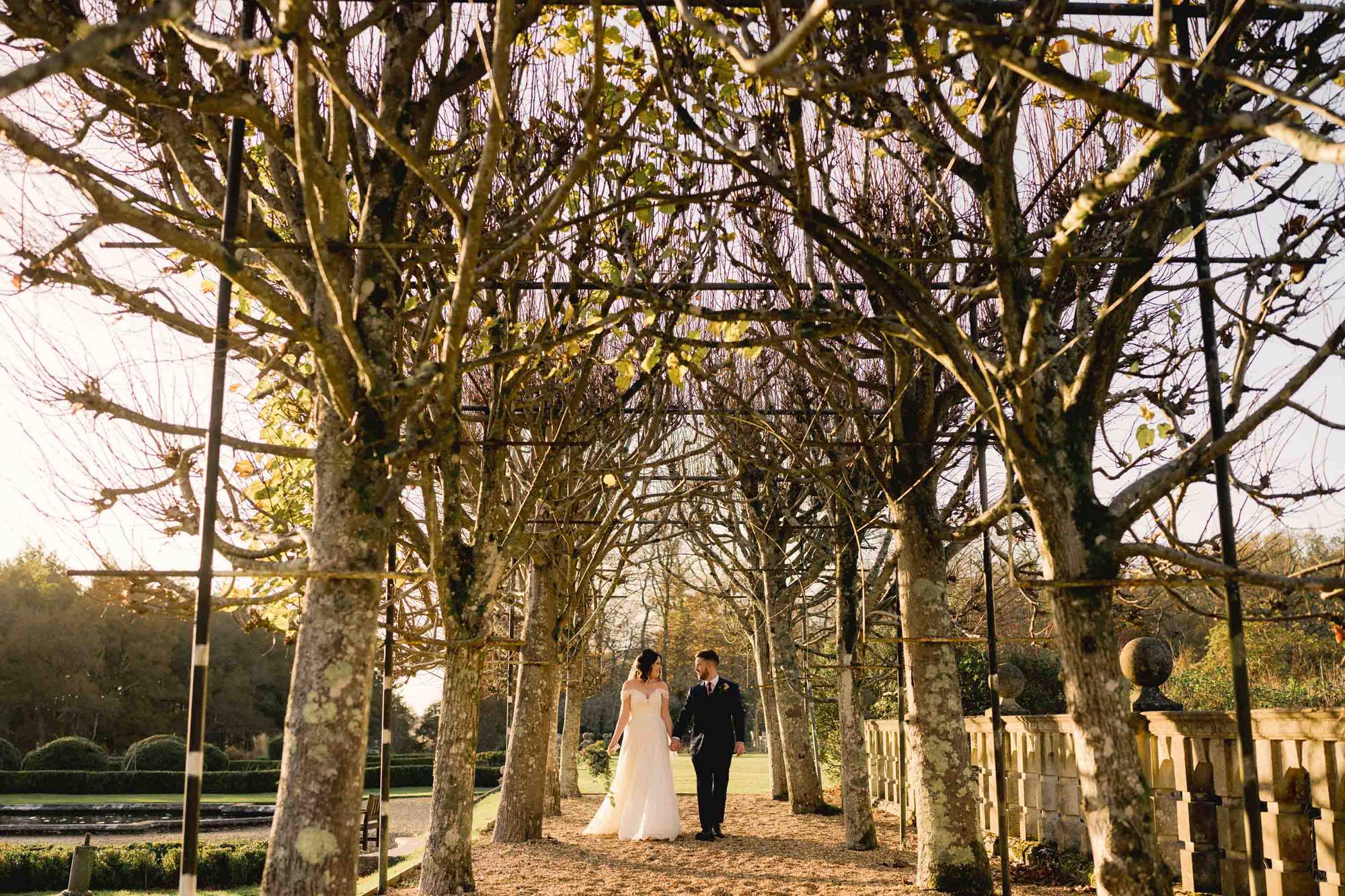 Bride and groom have a stroll together at Rhinefield House wedding venue in Hampshire.
