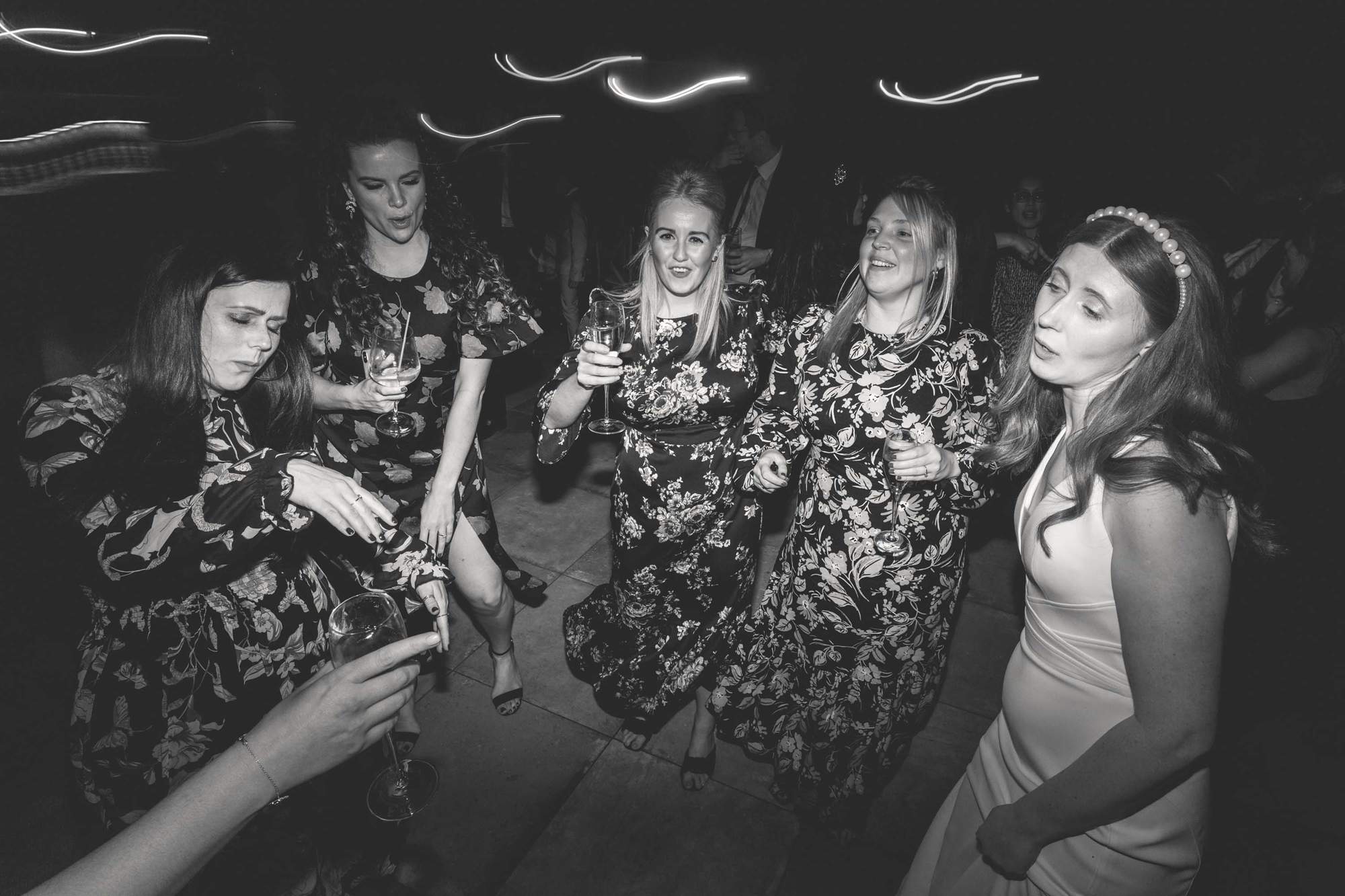 Bride dancing with her guests on the dance floor on her wedding day.
