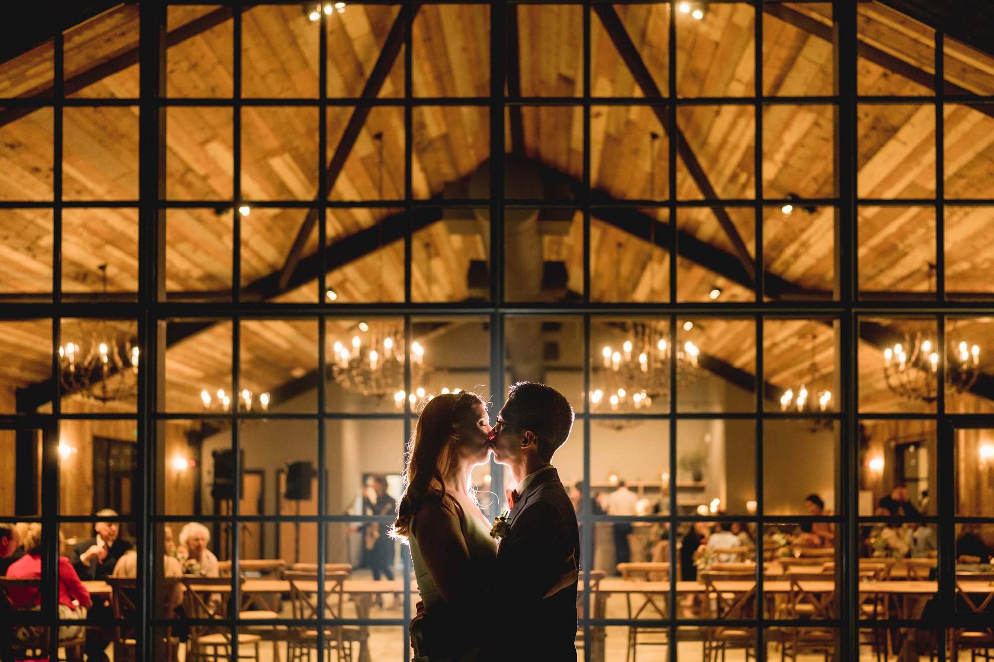 Bride and groom kiss at night time at the Botley Hill Barn wedding venue.