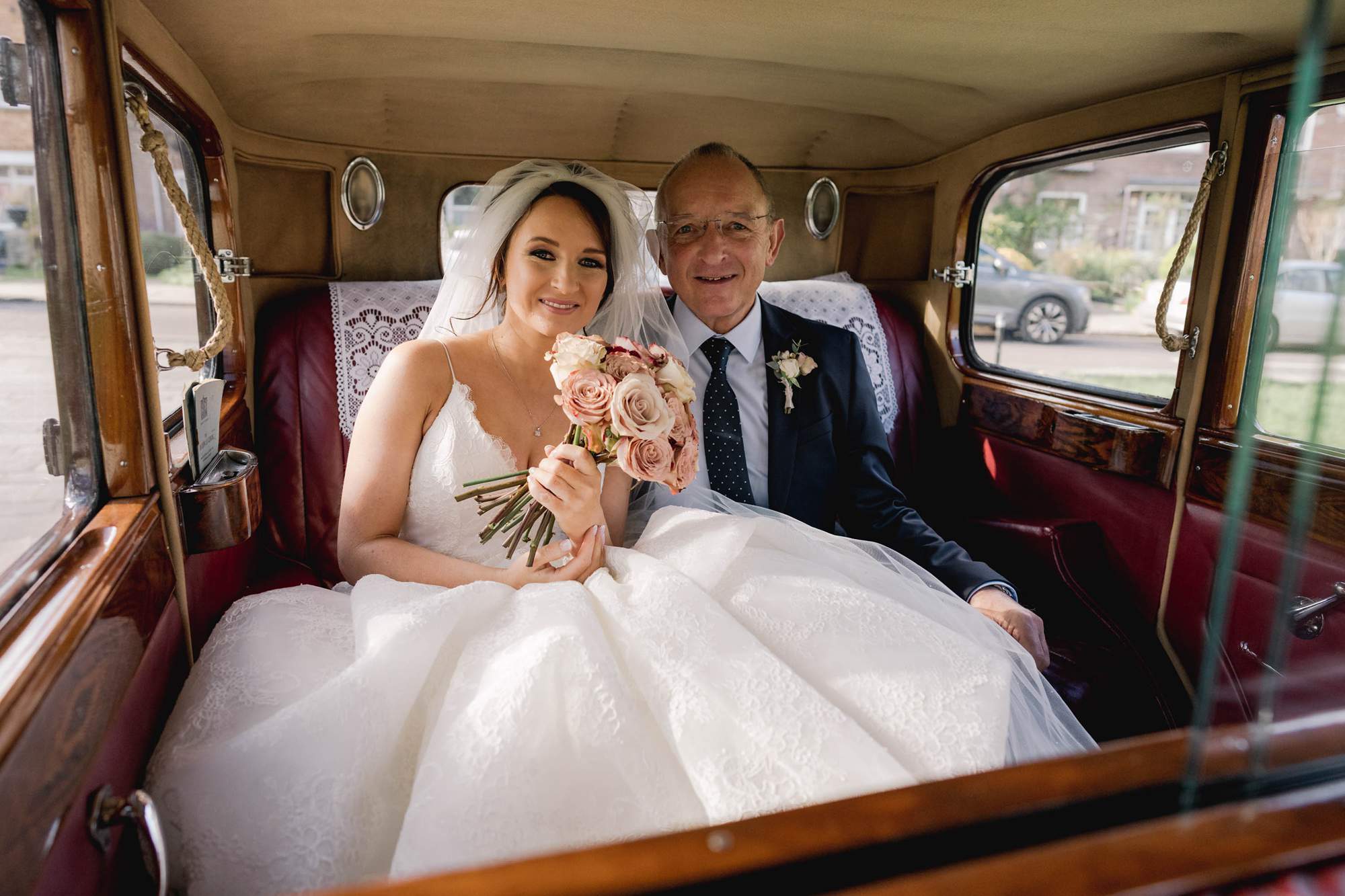 Bride and her father in a vintage Rolls Royce.