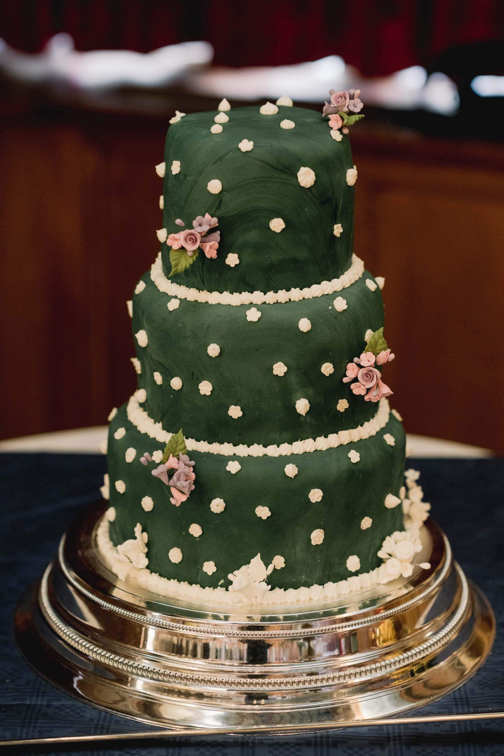 Green wedding cake with pink flowers.