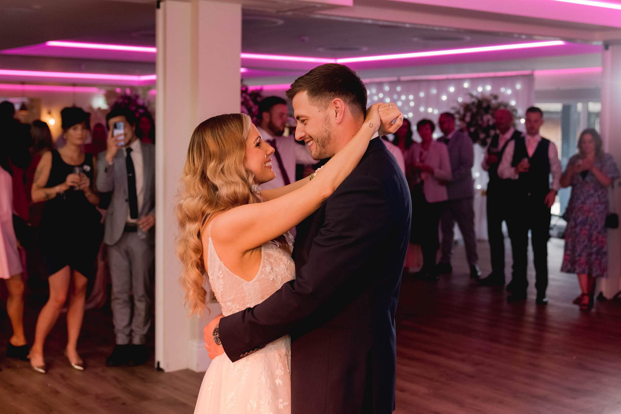 Bride and groom hold each other for their first dance at Cottesmore Golf Club.
