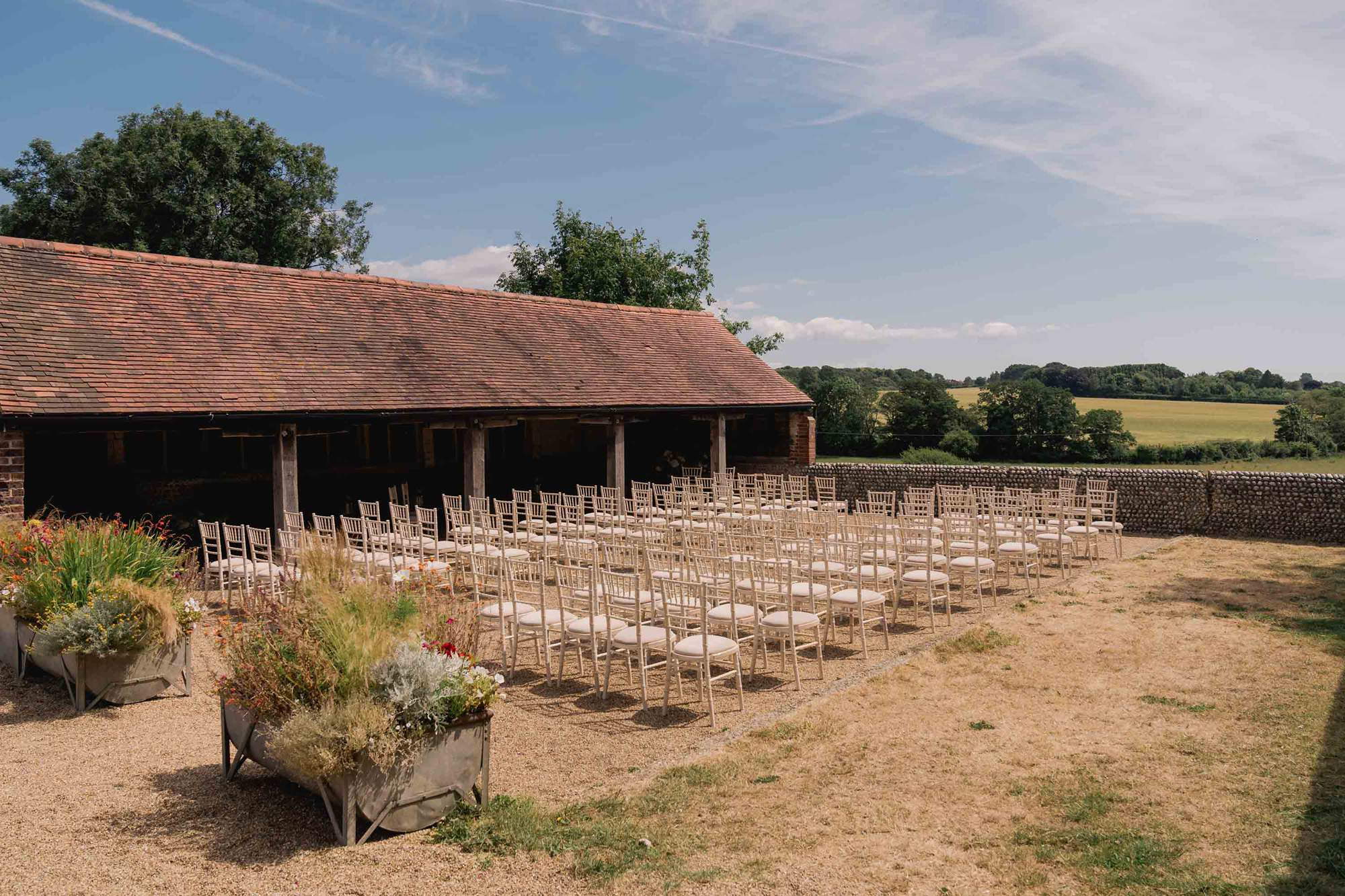 Outdoor wedding ceremony set up at the Sussex Barn wedding venue in Hellingly.