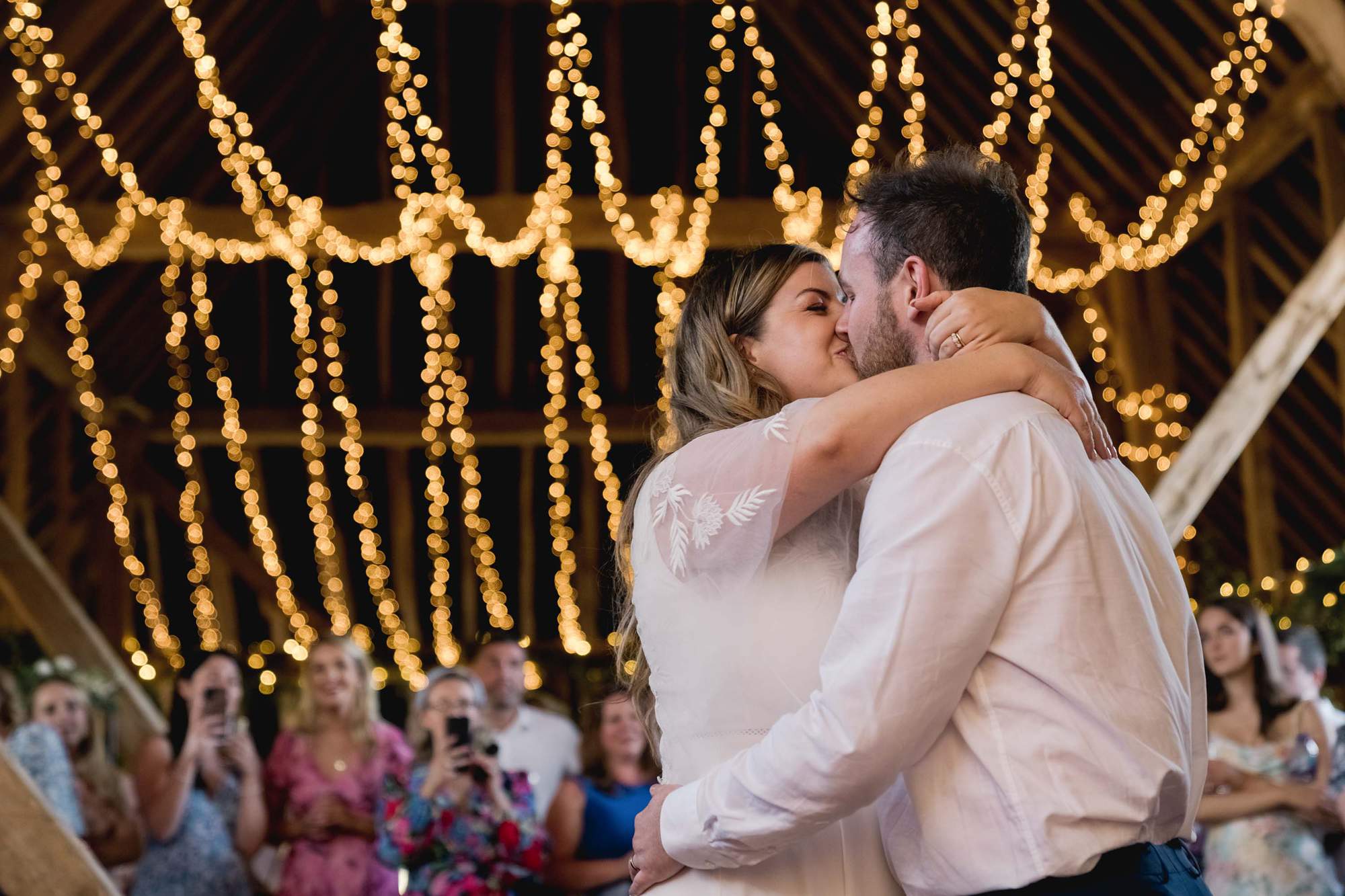 Bride and groom kiss during their first dance on their wedding day at the Sussex Barn.