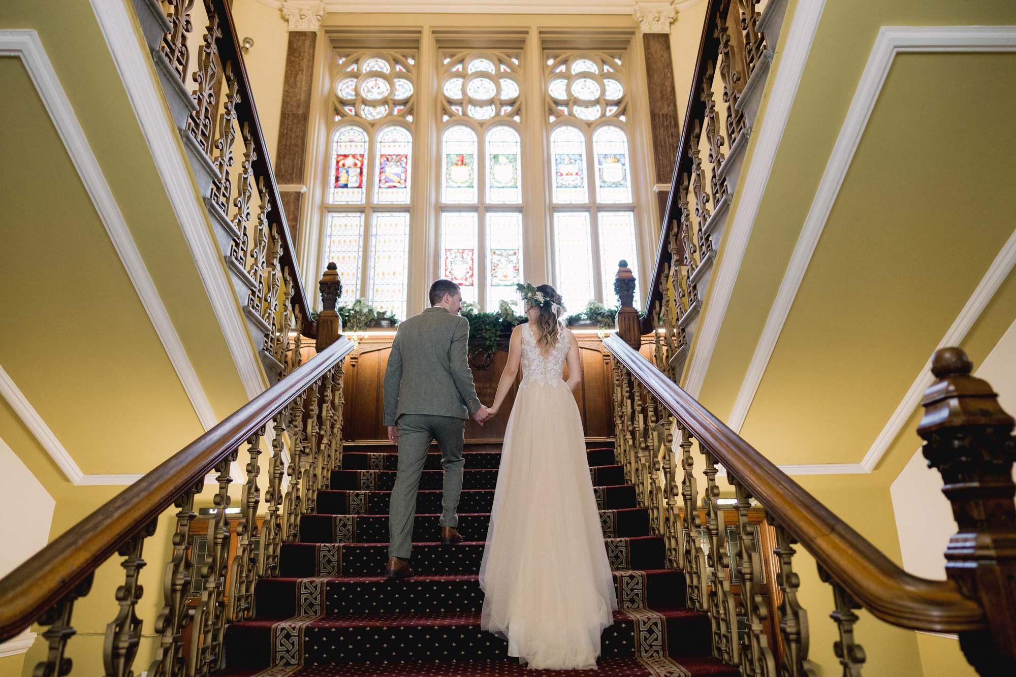 Bride's walks up the stairs with her new husband at Eastbourne Town Hall.