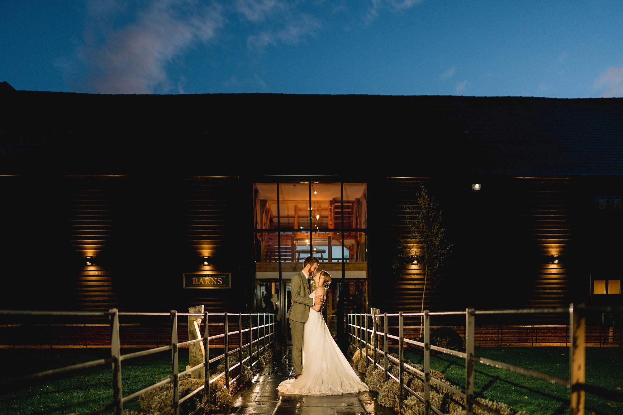 Bride and groom have a cuddle under a twilight sky at The Farmhouse at Redcoats in Hitchin.