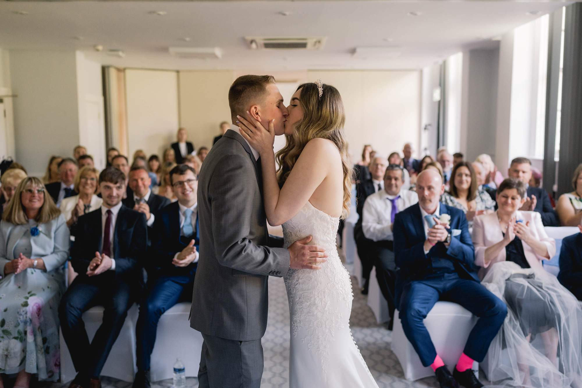 Newly wedded couple kiss during their wedding ceremony at the Avisford Park Hotel in Arundel, West Sussex.