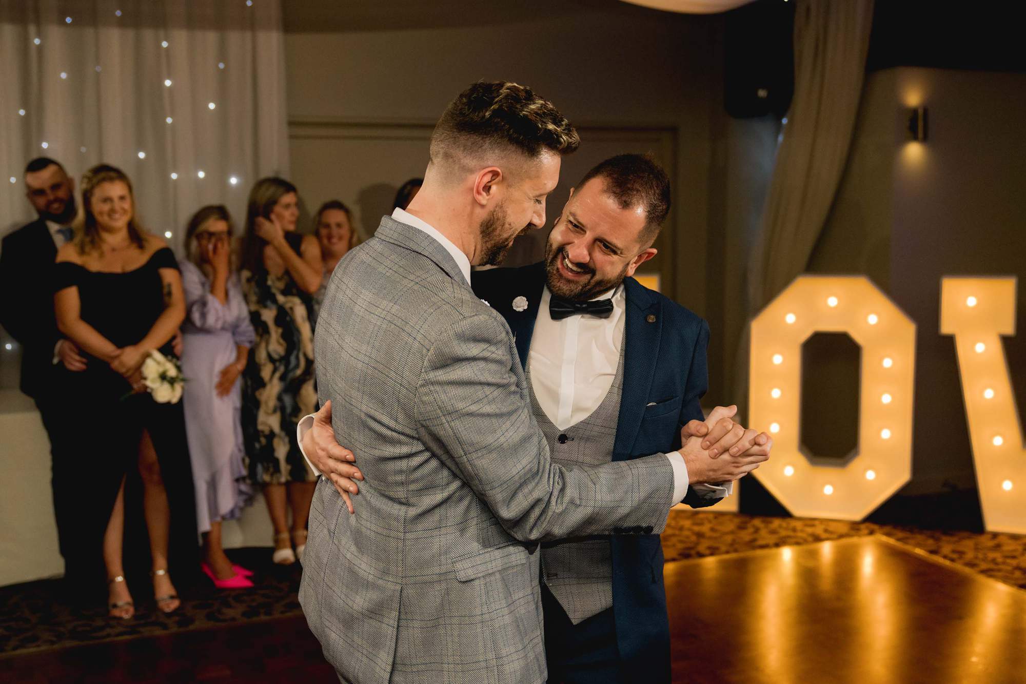 Two grooms have their first dance together on their wedding day at Wickwoods Country Club in East Sussex.