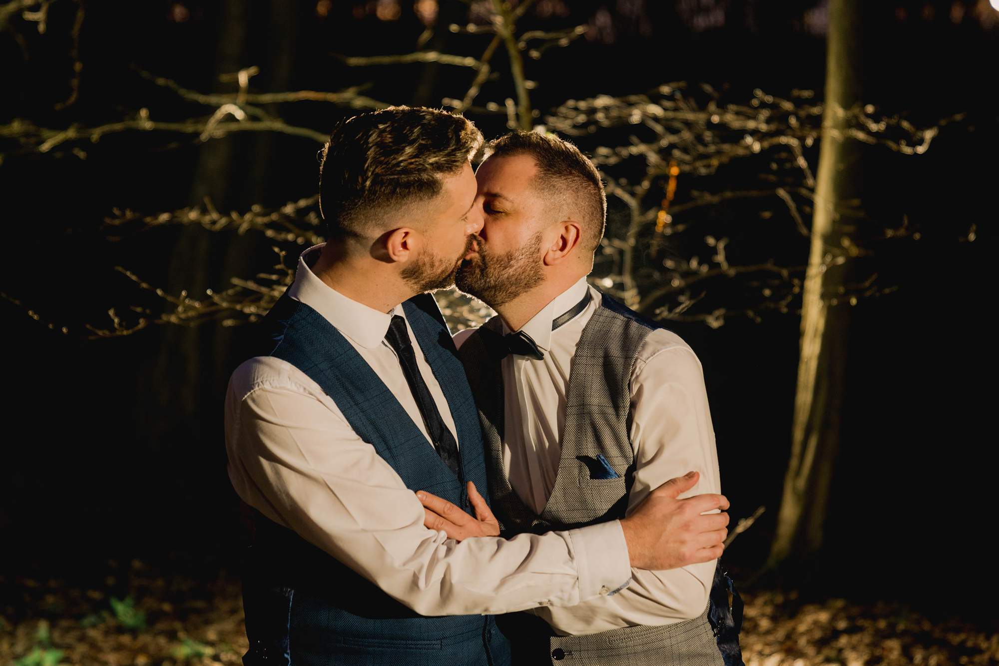 Two grooms kiss on their wedding day at Wickwoods.