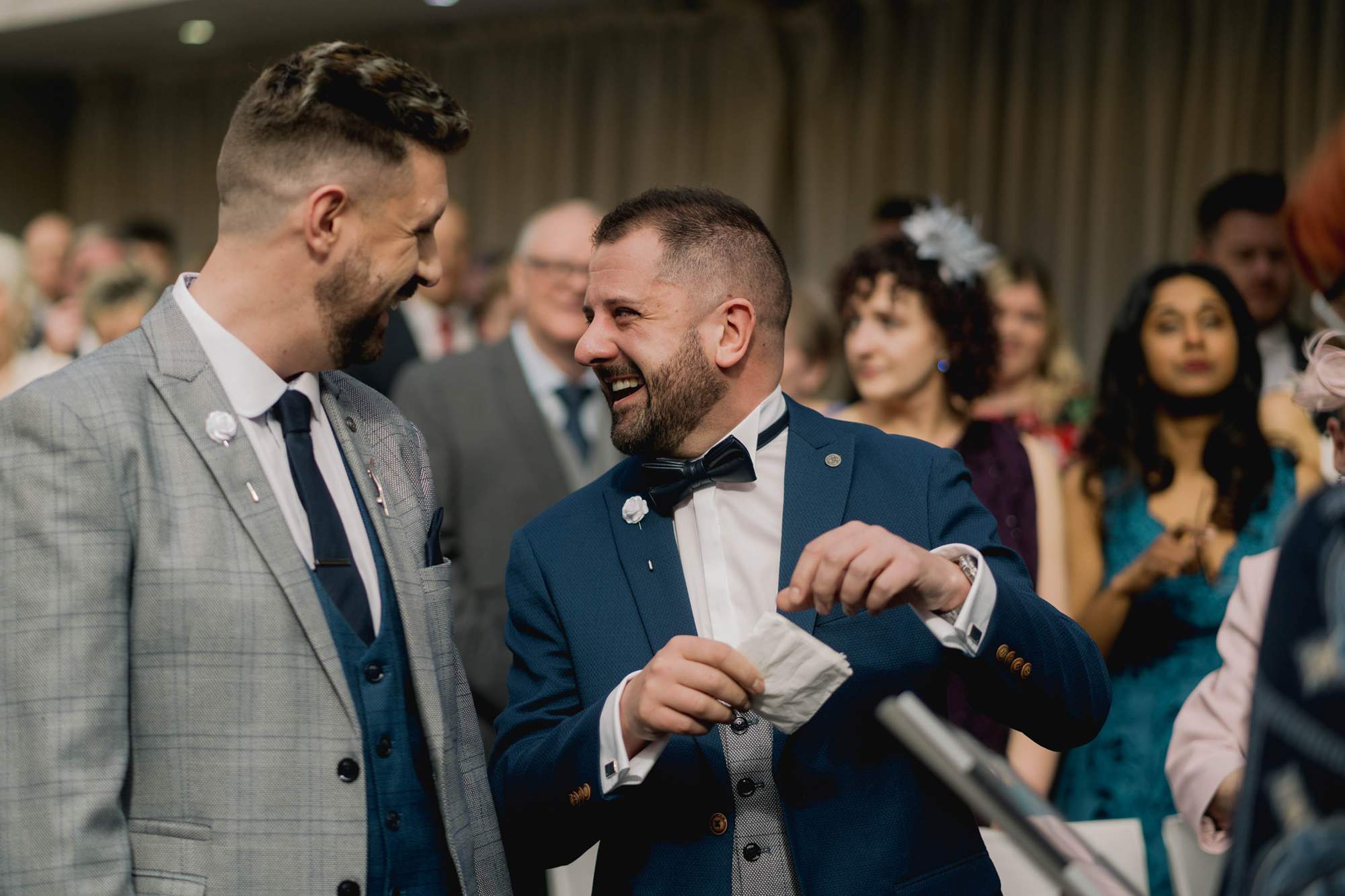 Two grooms share a moment during their wedding ceremony at Wickwoods Country Club in East Sussex.