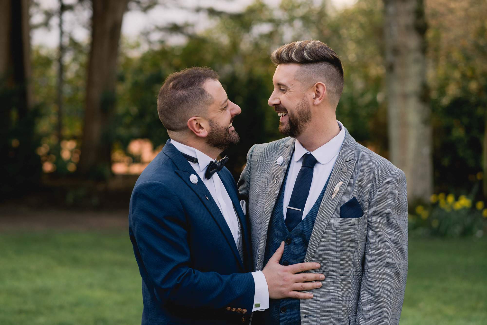 Two grooms stare lovingly in to each other's eyes on their wedding day at Wickwoods Country Club in East Sussex.