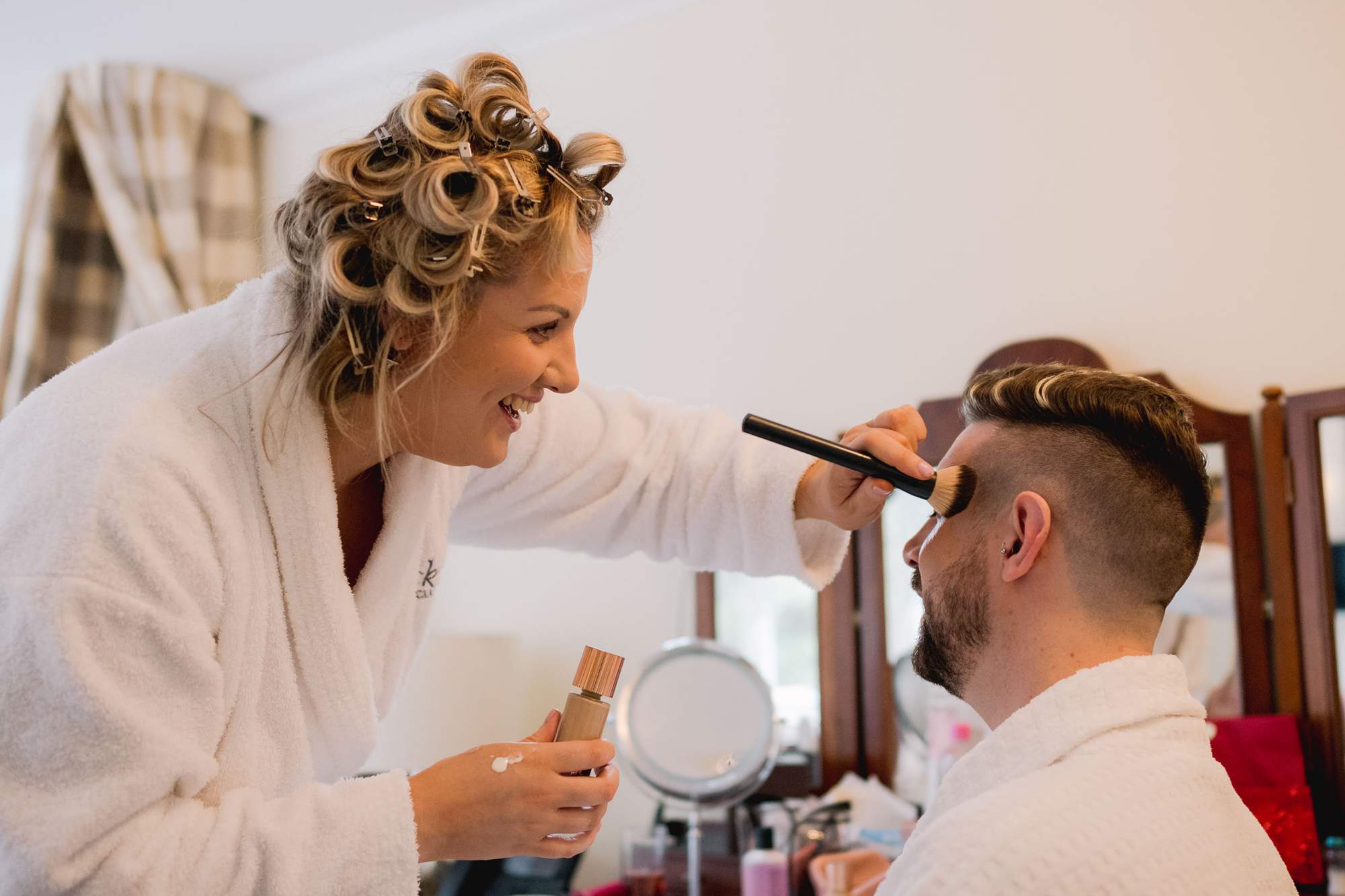 Groom having make up done at Wickwoods Country Club in East Sussex.