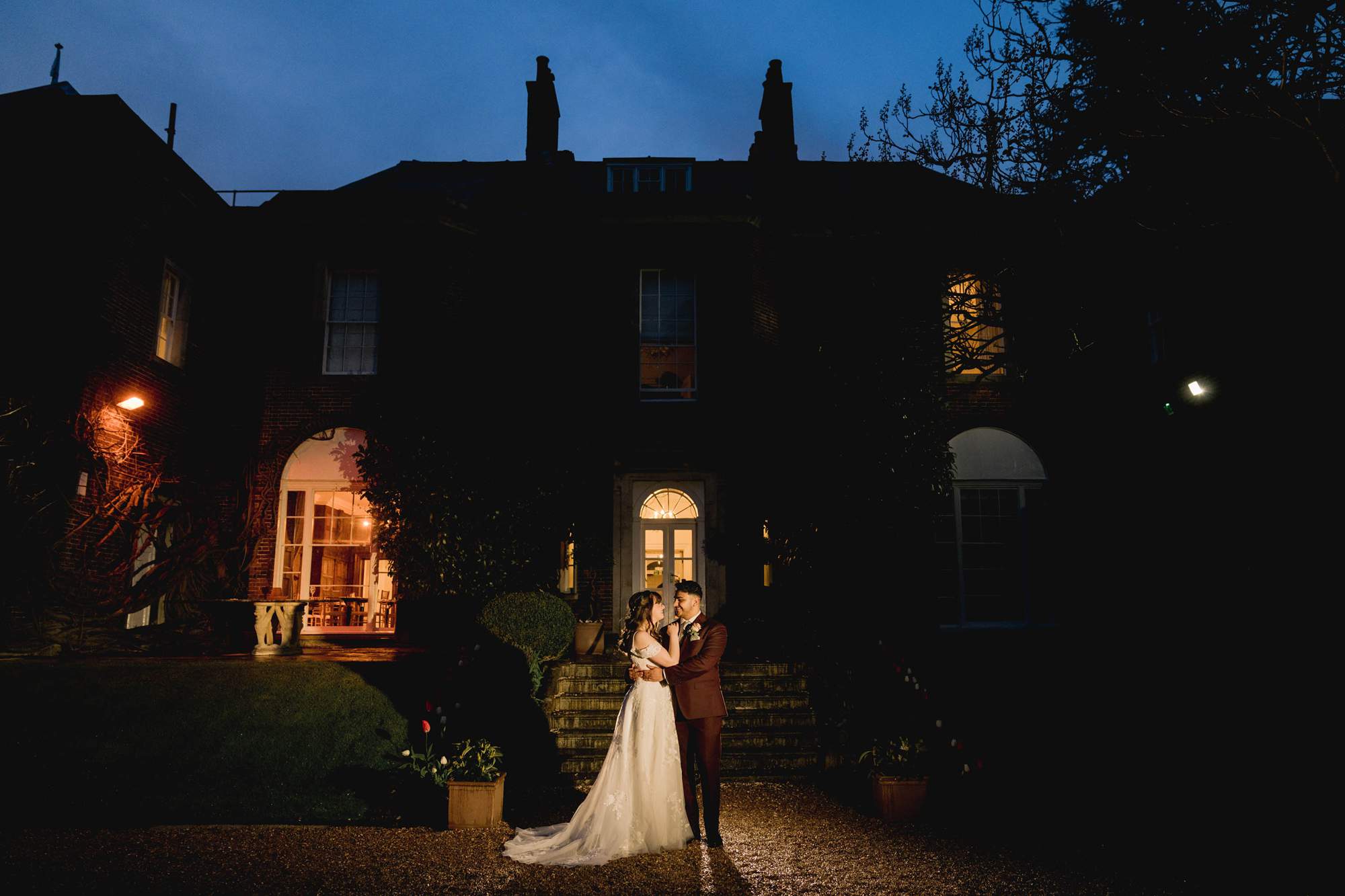 Bride and groom hug closely on their wedding day under the stars at Pelham House.