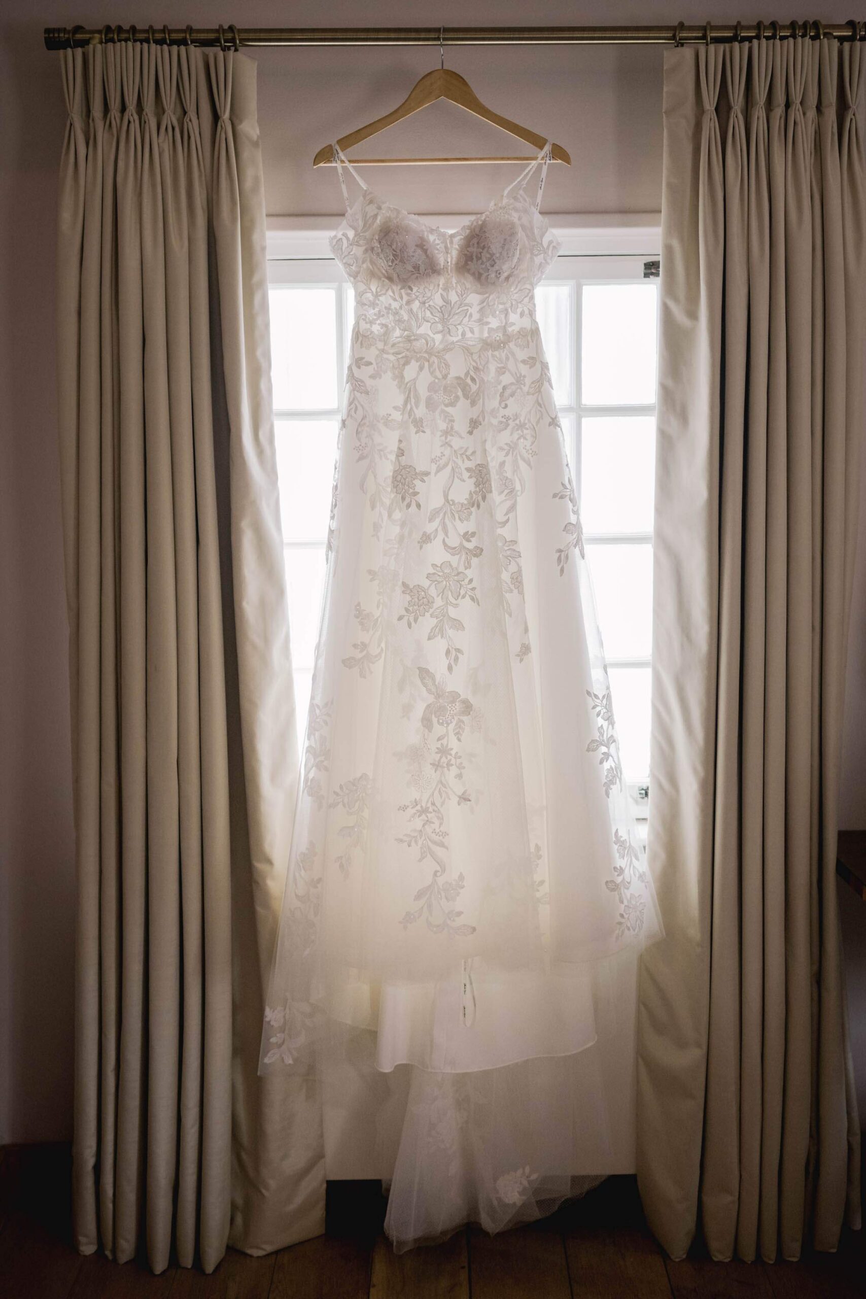 Wedding dress hanging up at the window at Pelham House in Lewes.