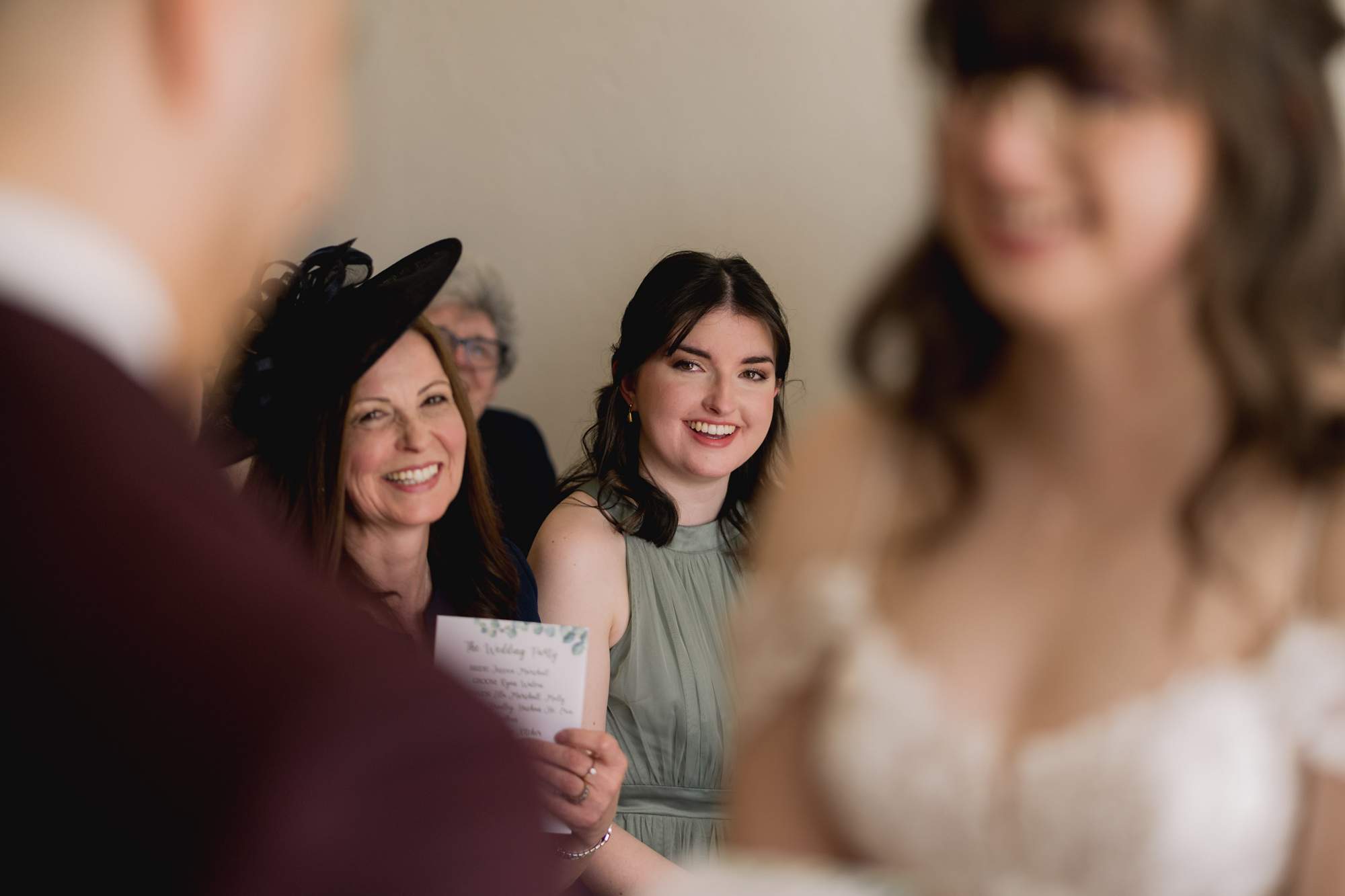 A guest laughing at a wedding at Pelham House in East Sussex.