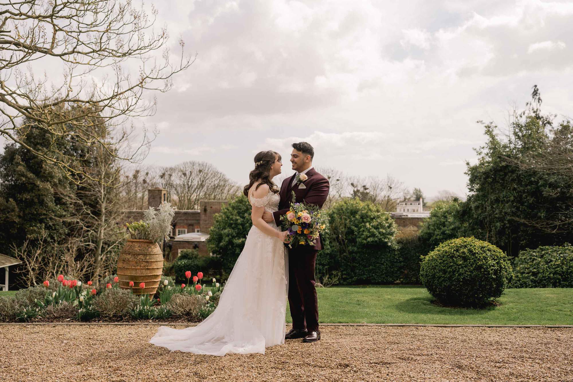Bride and groom hug closely on their wedding day at Pelham House in East Sussex.