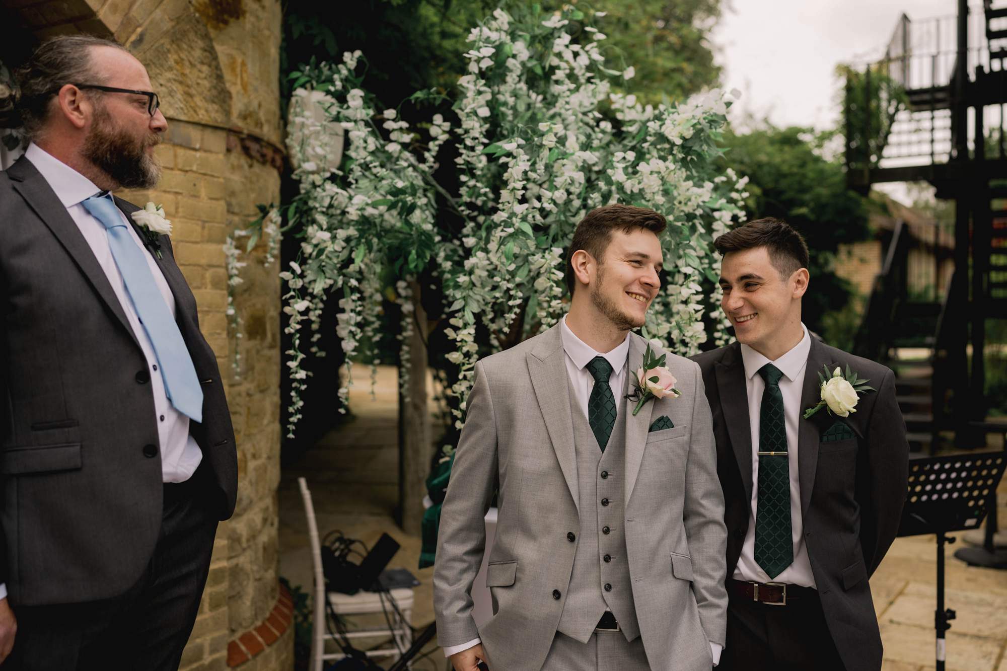 Groomsmen sharing a funny moment before the ceremony at the Ravenswood Hotel in Sussex.