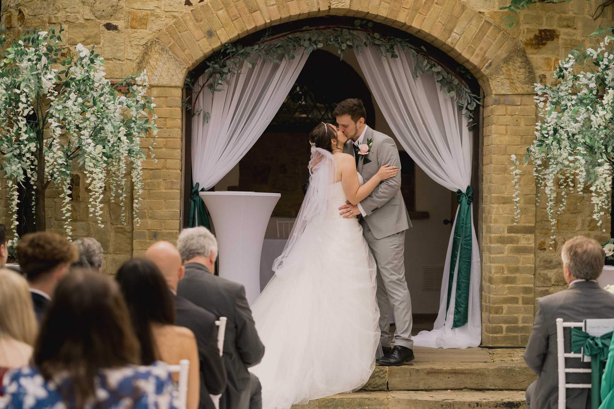 Bride and groom have their first kiss as man and wife at the Ravenswood Hotel in Sussex.