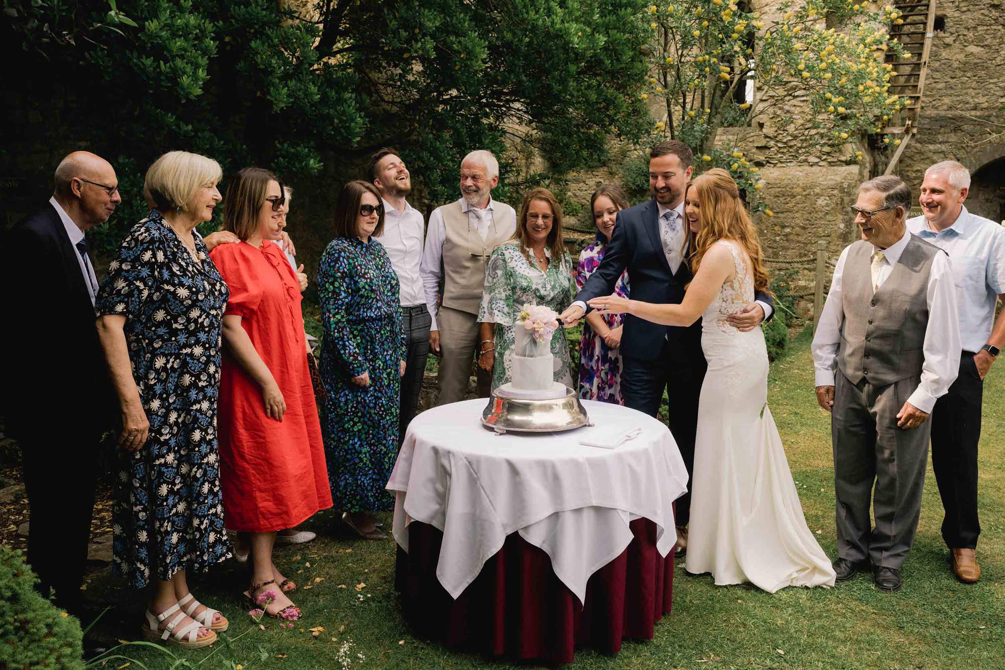 Bride and groom cut the cake at Amberley Castle in West Sussex.
