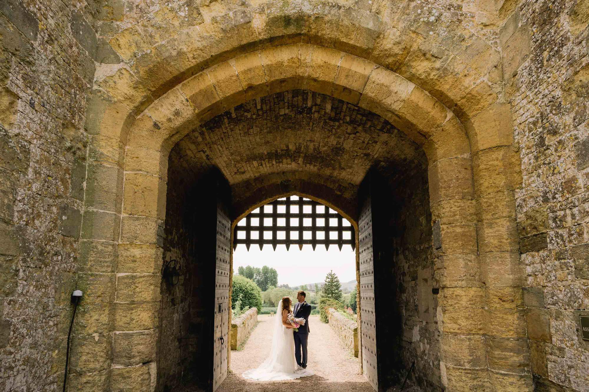 Bride and groom stare lovingly in to each other's eyes on their wedding day at Amberley Castle in West Sussex.