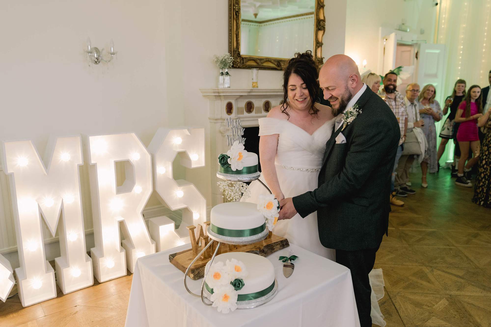 Bride and groom cut the cake at Highley Manor wedding reception.