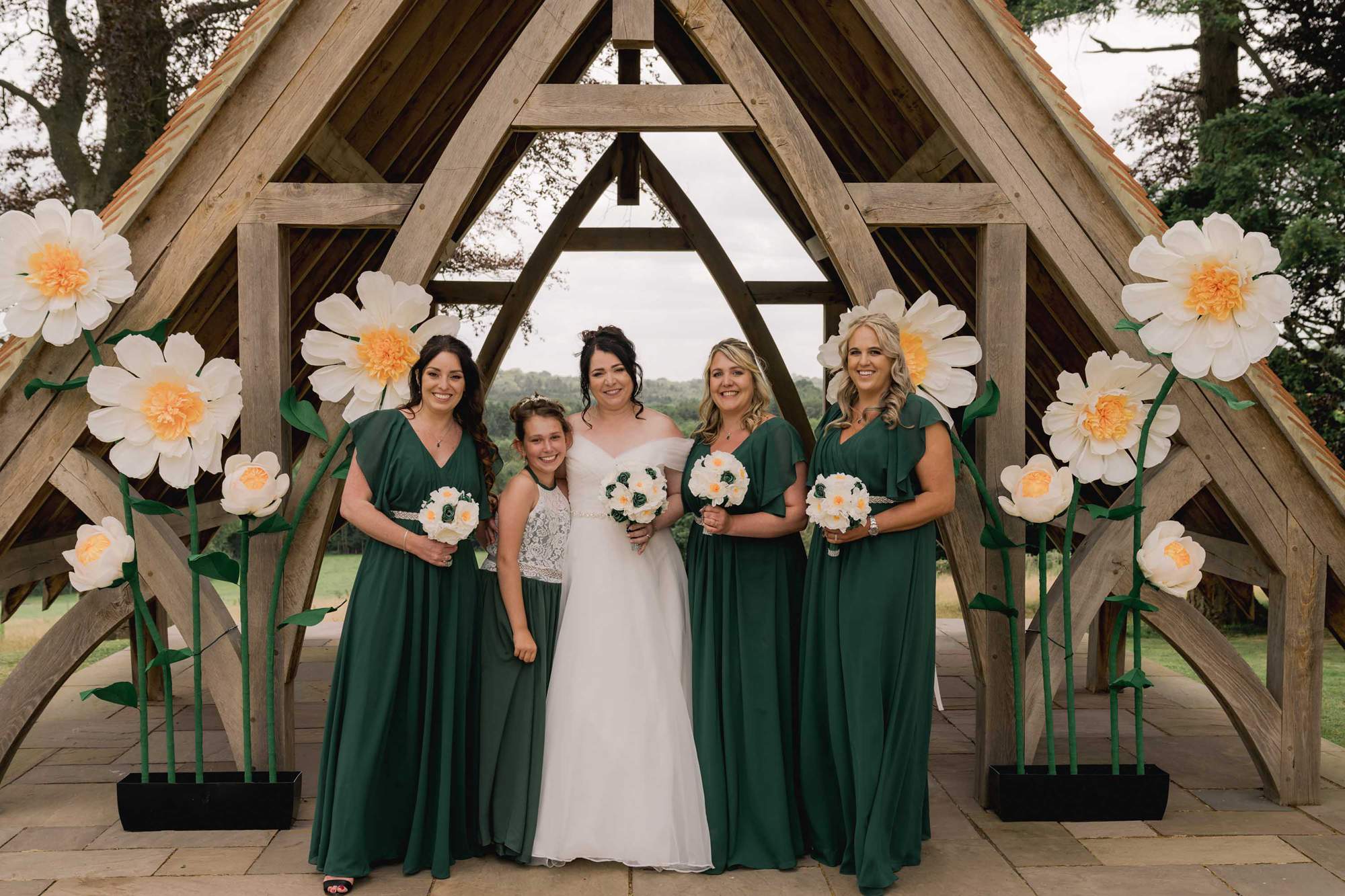 Bride and her bridesmaids and flower girl at Highley Manor wedding venue in Sussex.