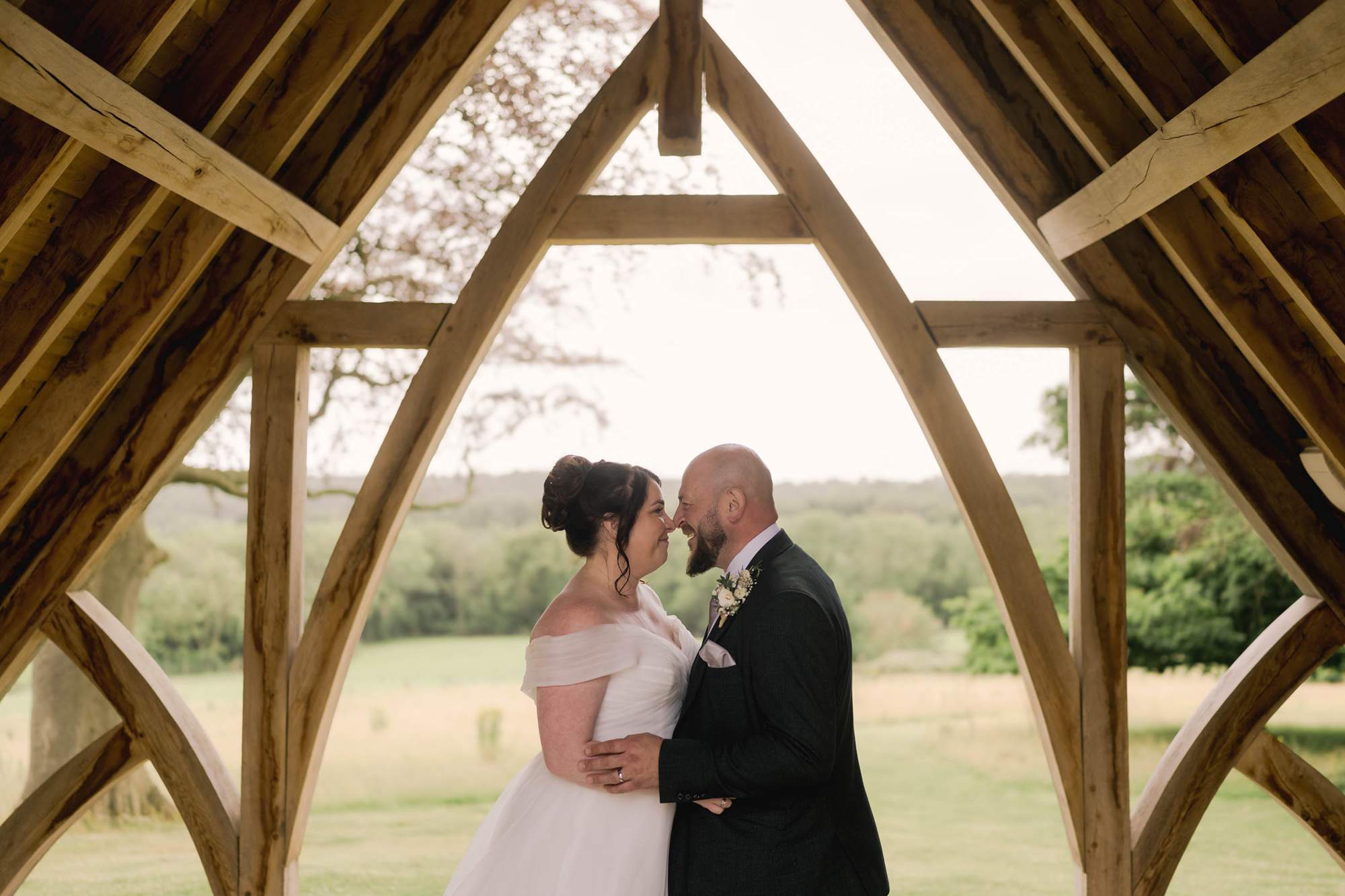 Couple touch noses at Highley Manor on their wedding day.