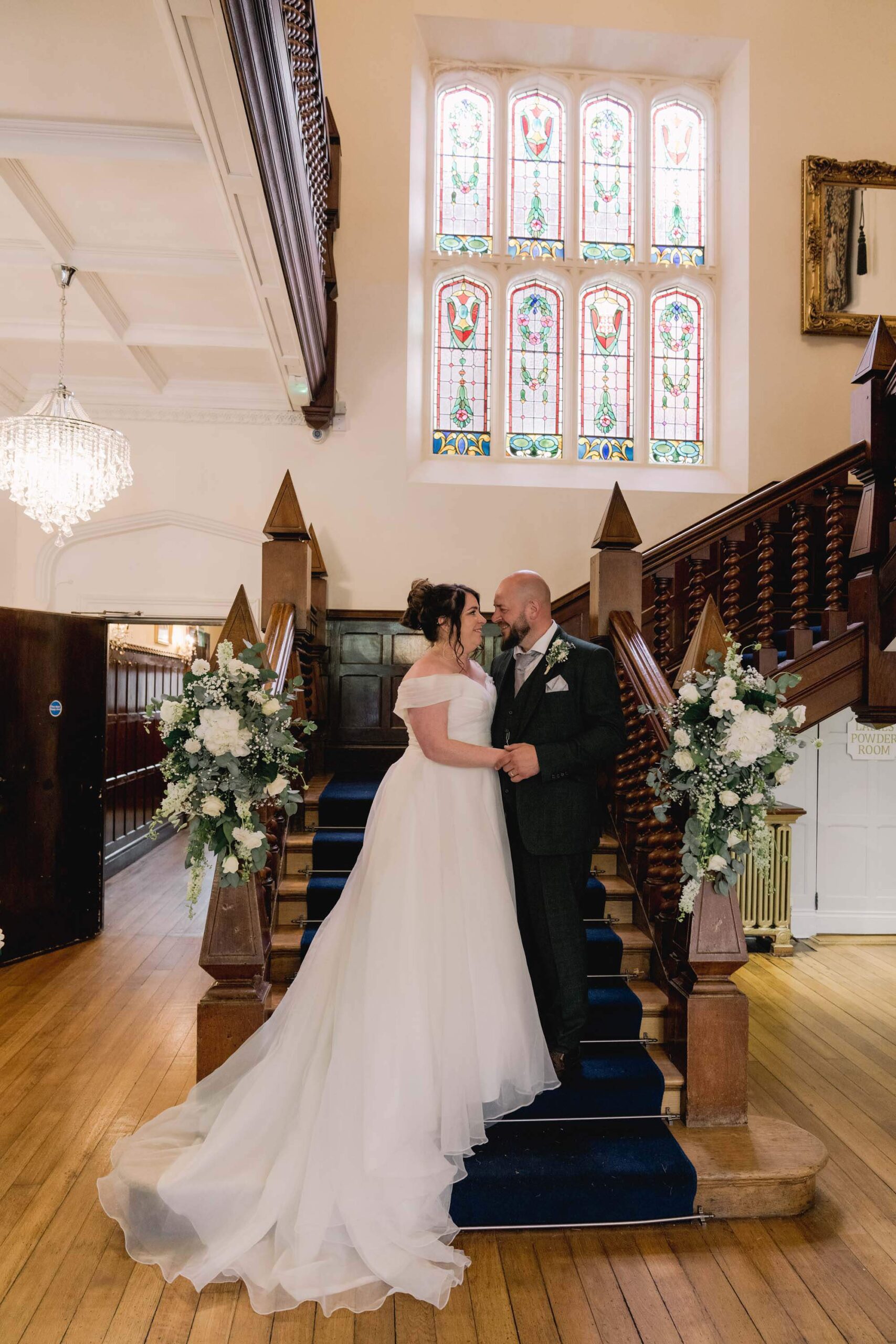 Bride and groom on the stairs at Highley Manor wedding venue.