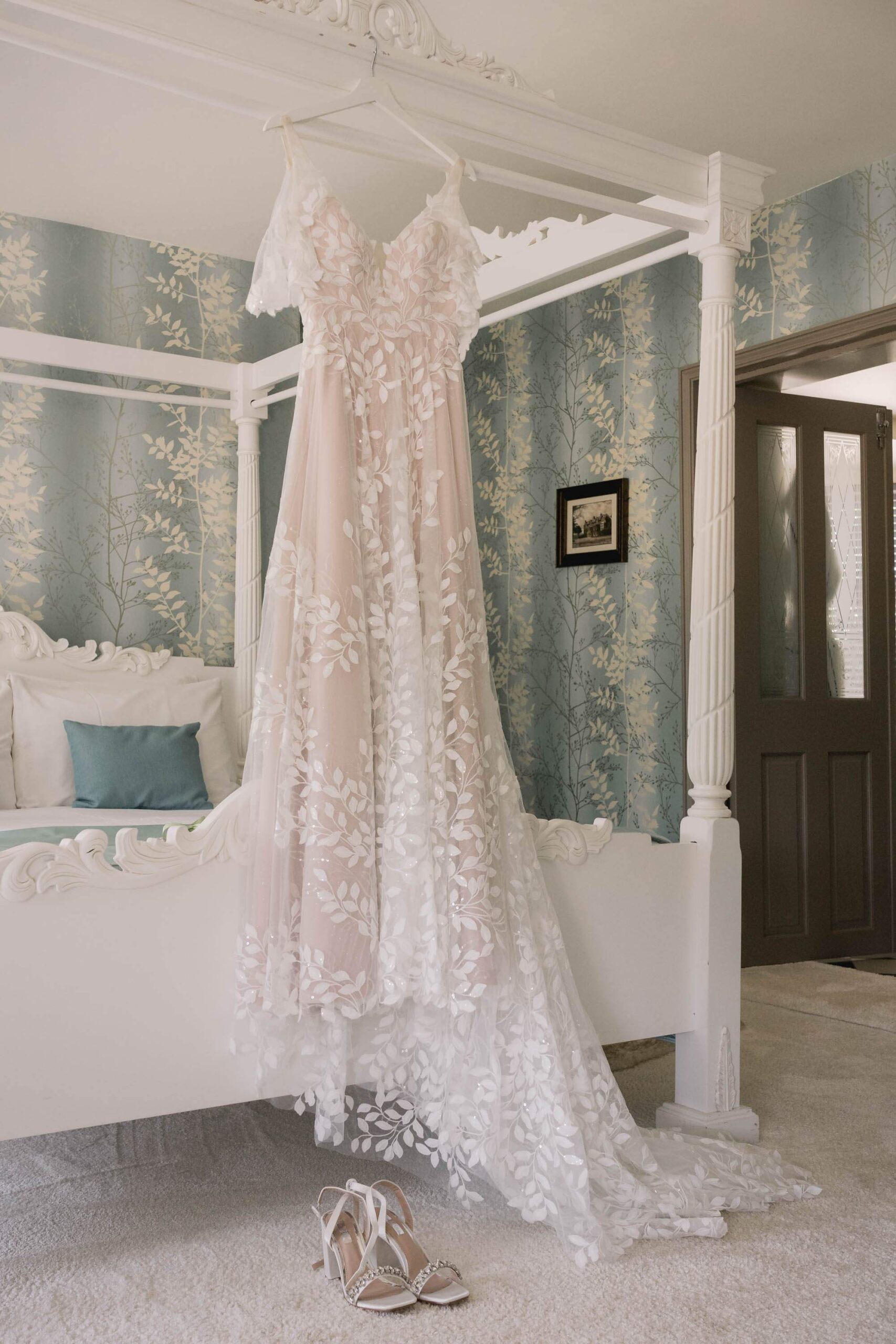 Dress and shoes in the bridal suite at Southdowns Manor wedding venue.