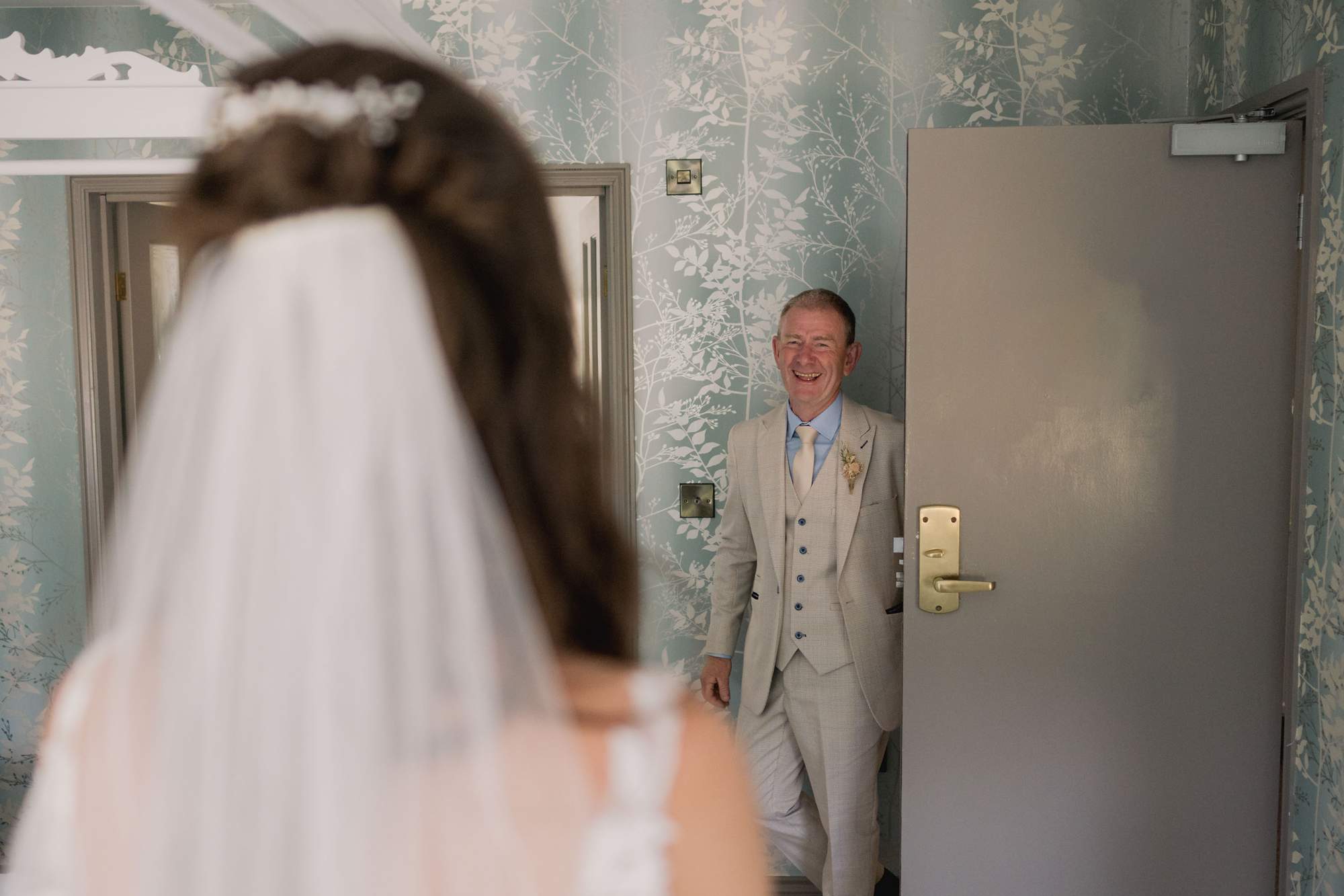 Father of the bride sees his beautiful daughter for the first time in her wedding dress at Southdowns Manor.