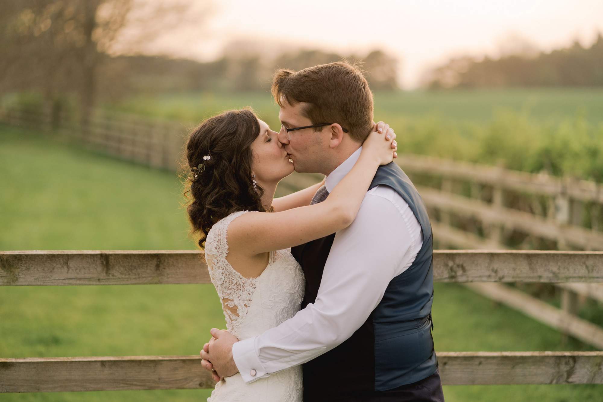 Bride and groom kiss on their wedding day at Swallows Nest Barn in Warwickshire.