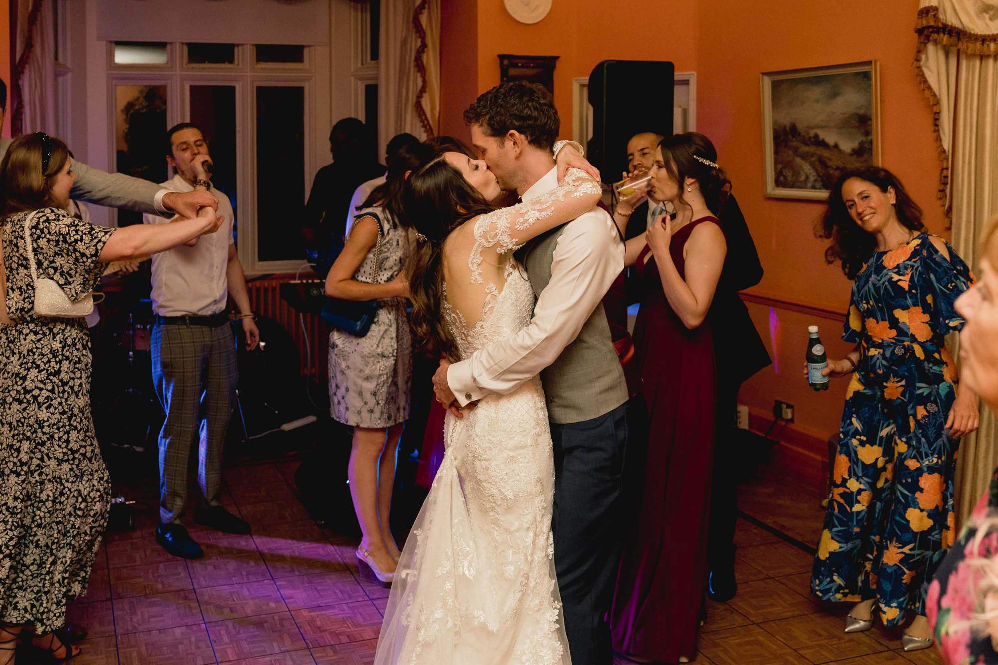 Bride and groom kiss on the dance floor at Wadhurst Castle.
