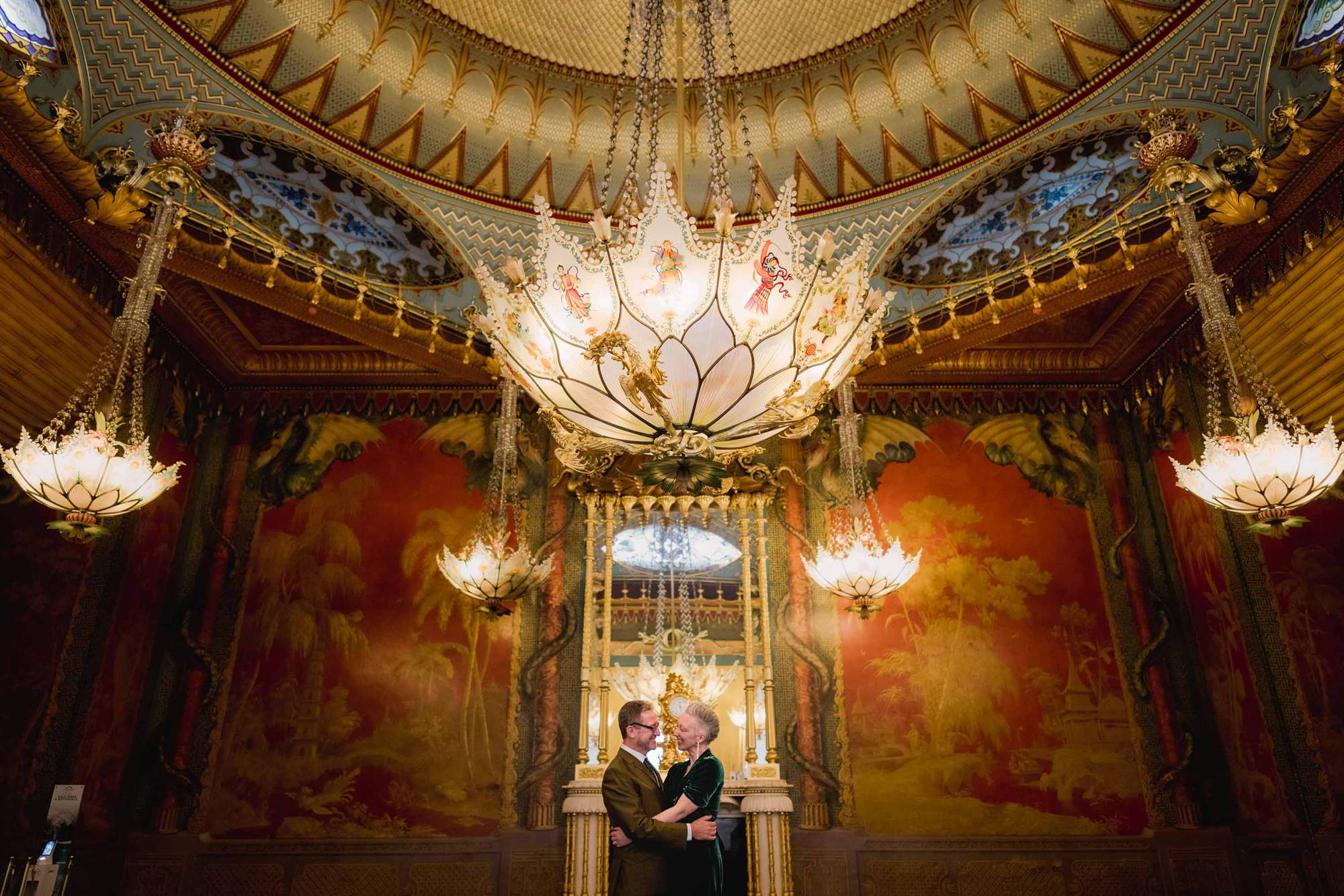 Bride and Groom hug each other in the Music Room at the Brighton Royal Pavilion in East Sussex.