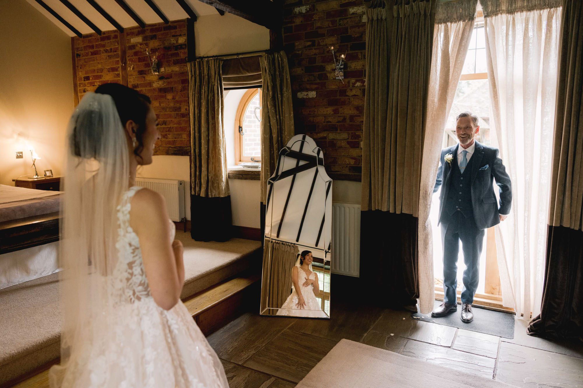 First look between the father of the bride and his daughter at Rivervale Barn in Hampshire.