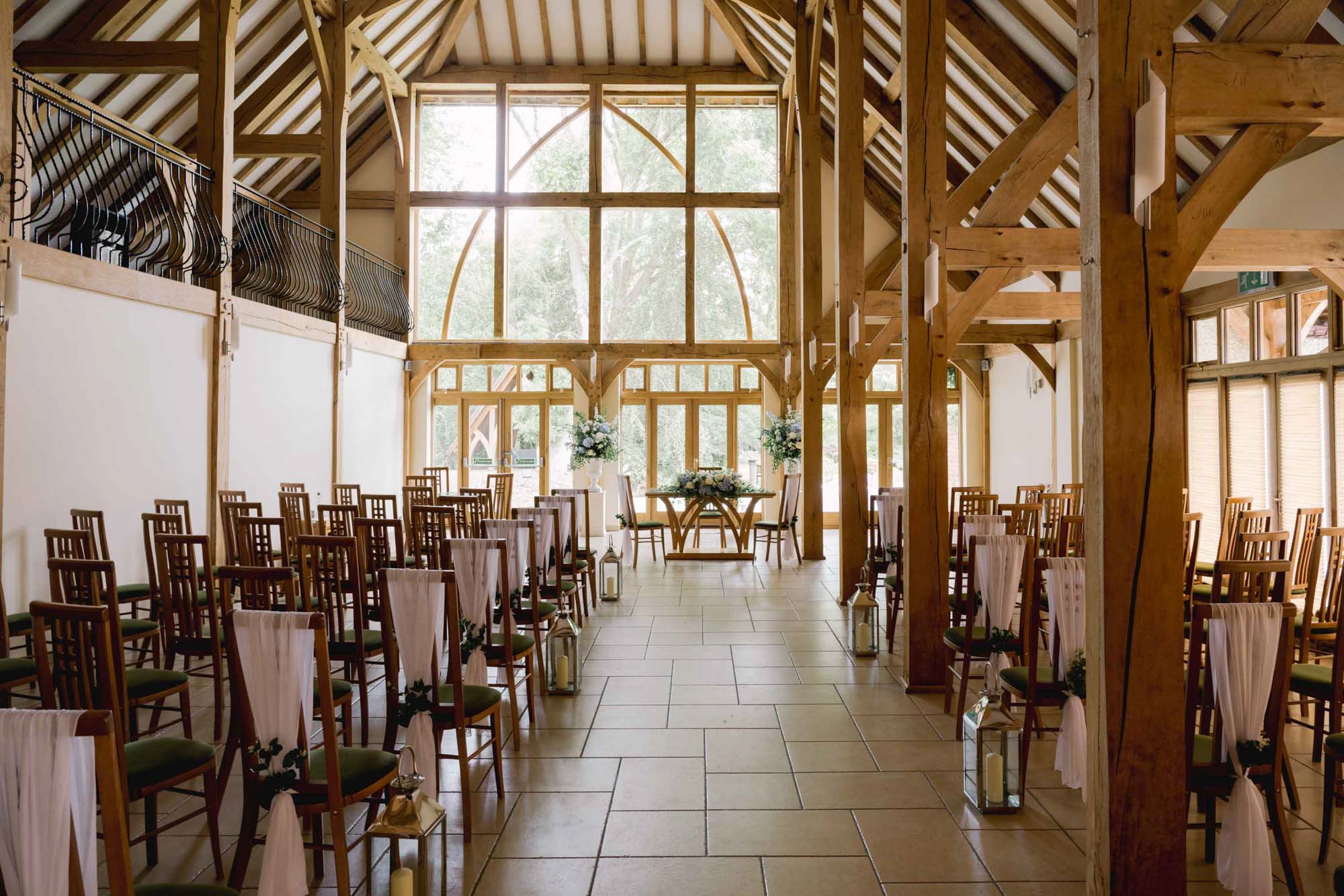 The wedding ceremony setup indoors at Rivervale Barn in Hampshire.