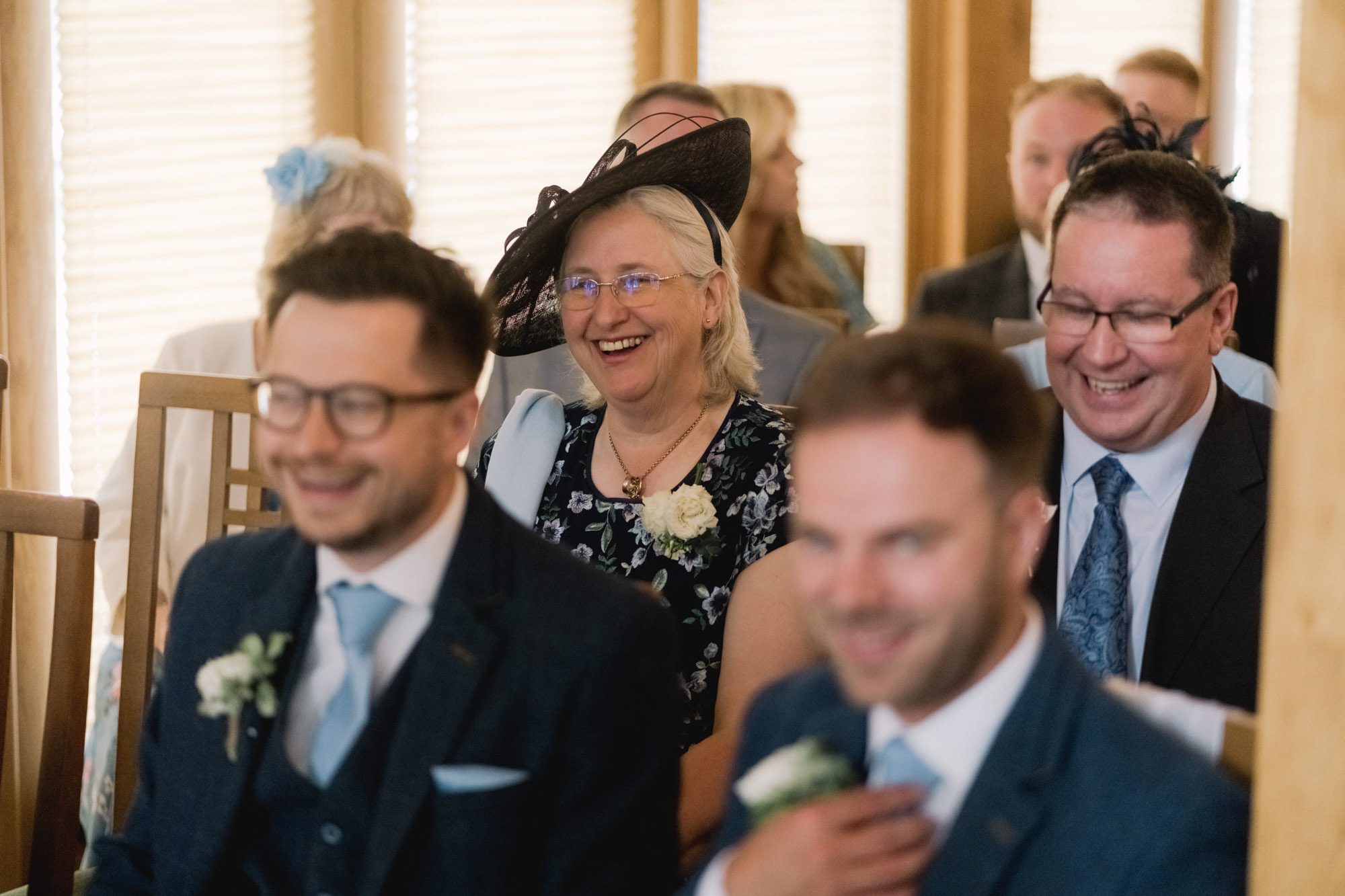 A guest smiling at a wedding at Rivervale Barn in Hampshire.