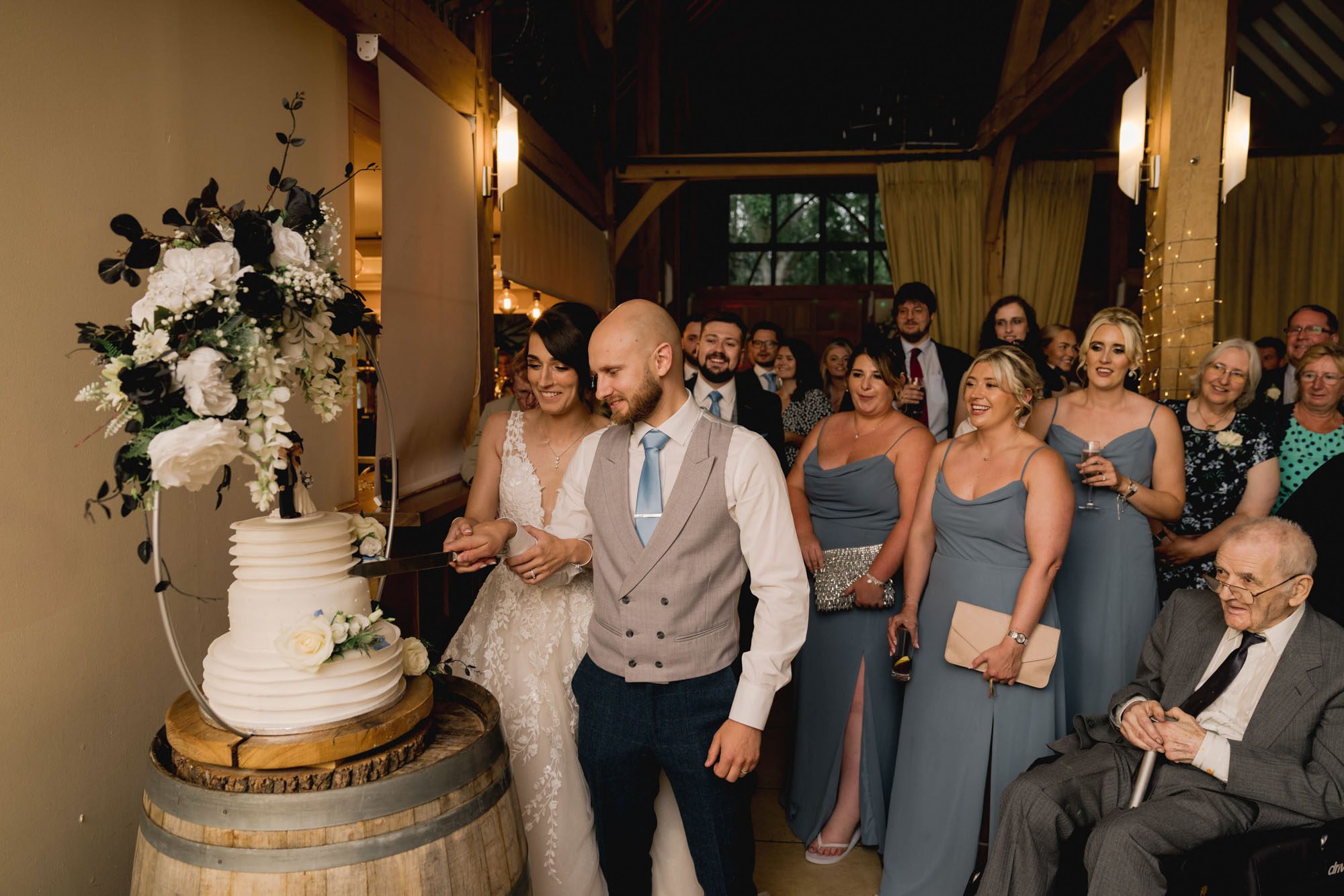 Bride and groom cut their wedding cake at Rivervale Barn in Hampshire.