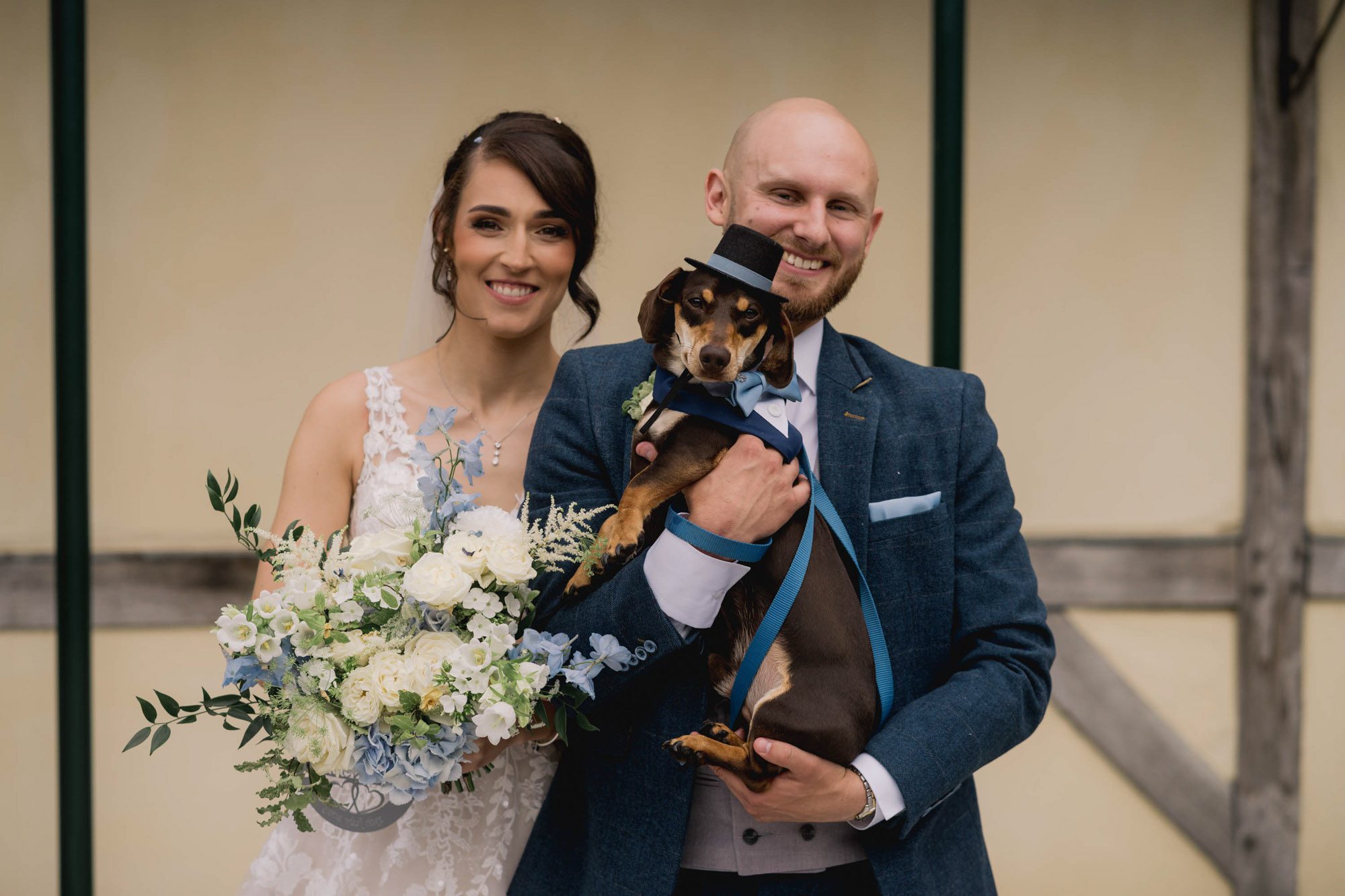 Bride and groom with their dog at Rivervale Barn in Hampshire.