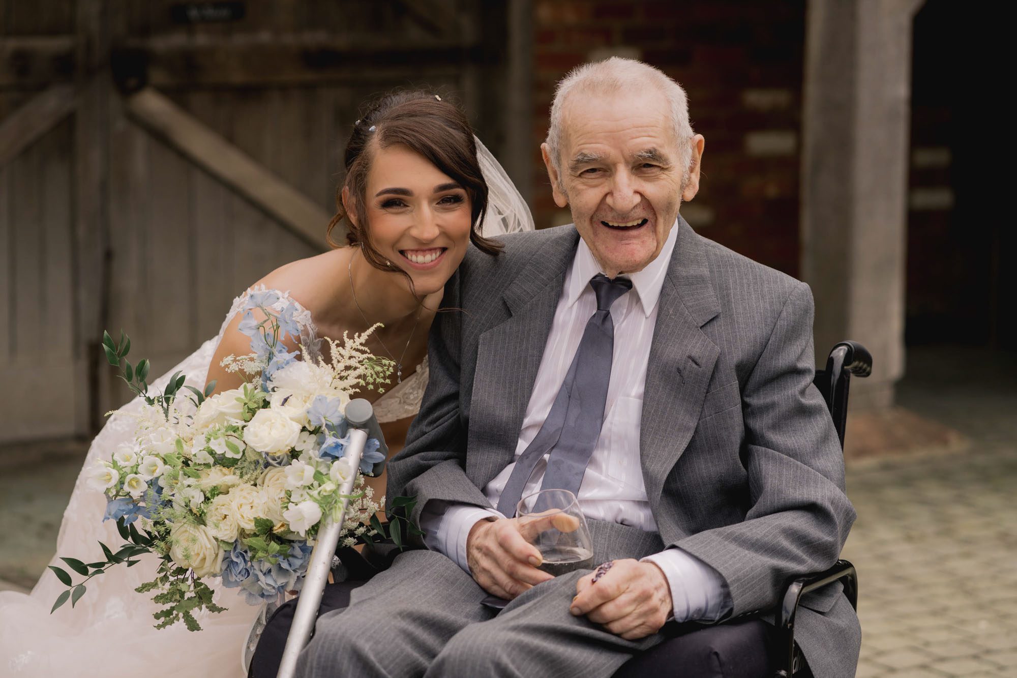 The bride with her grandfather on her wedding day at Rivervale Barn in Hampshire.