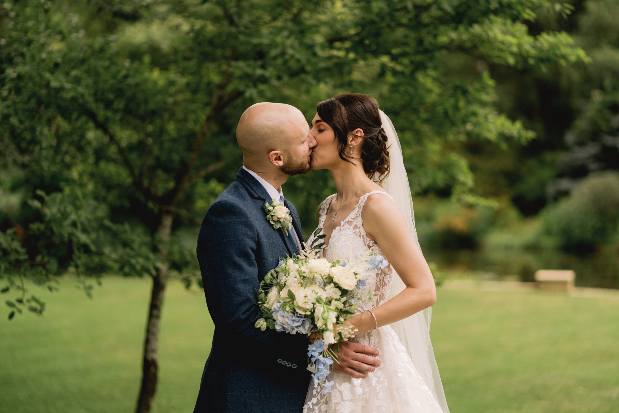 Bride and groom kiss on their wedding day at Rivervale Barn in Hampshire.