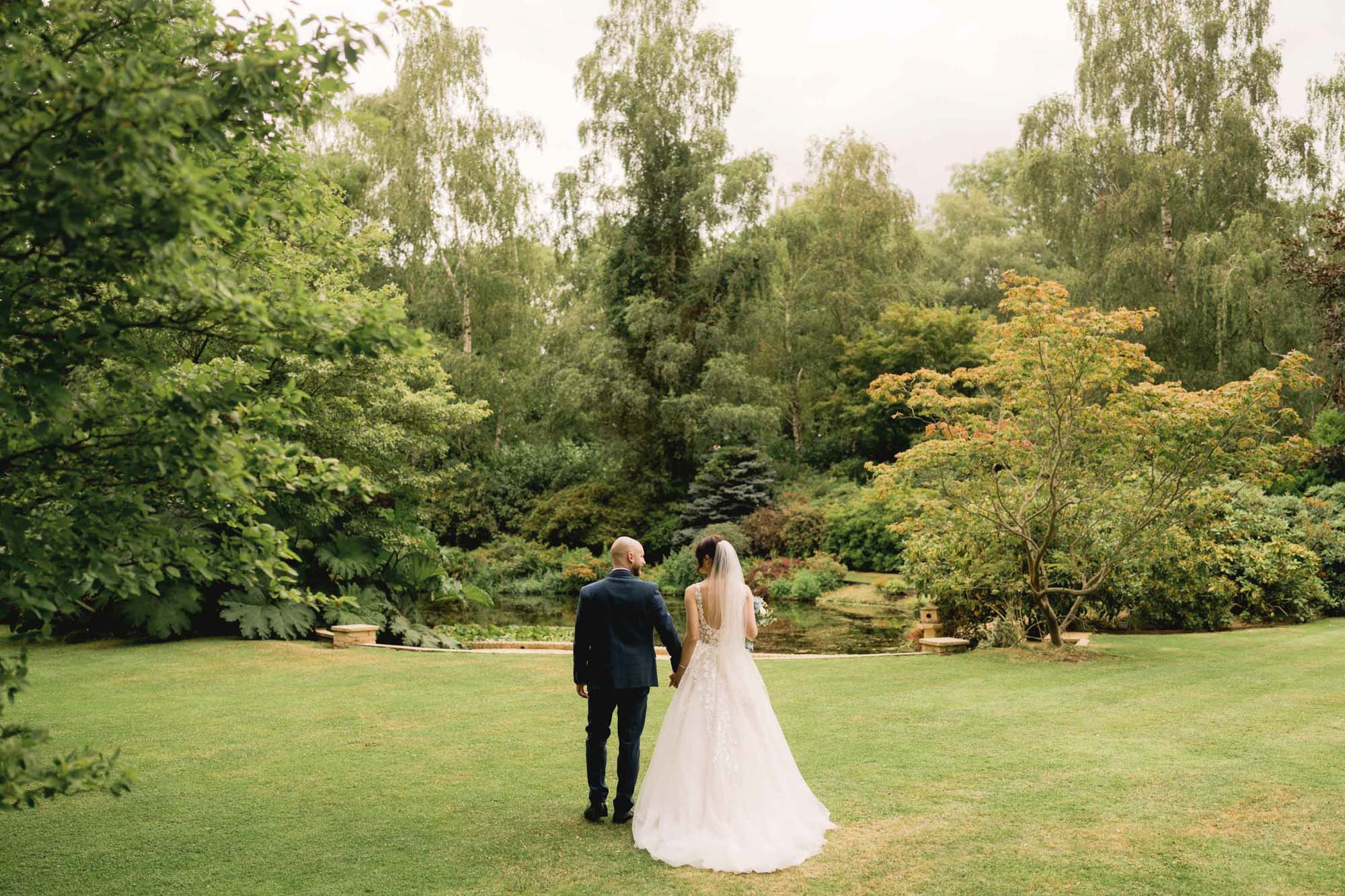 Bride and groom take a stroll on their wedding day at Rivervale Barn venue.
