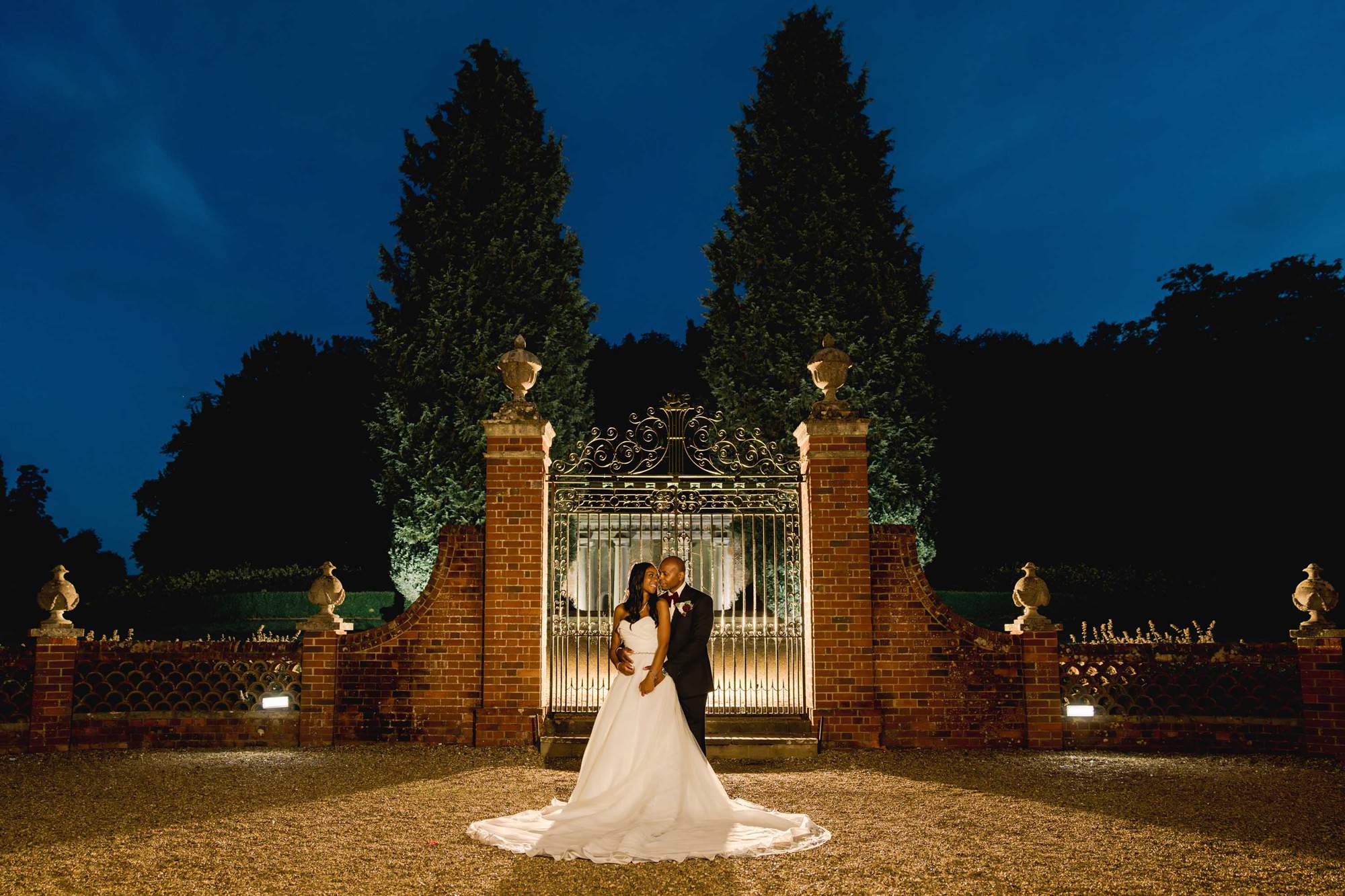 Bride and groom hug closely at Wotton House in Dorking.