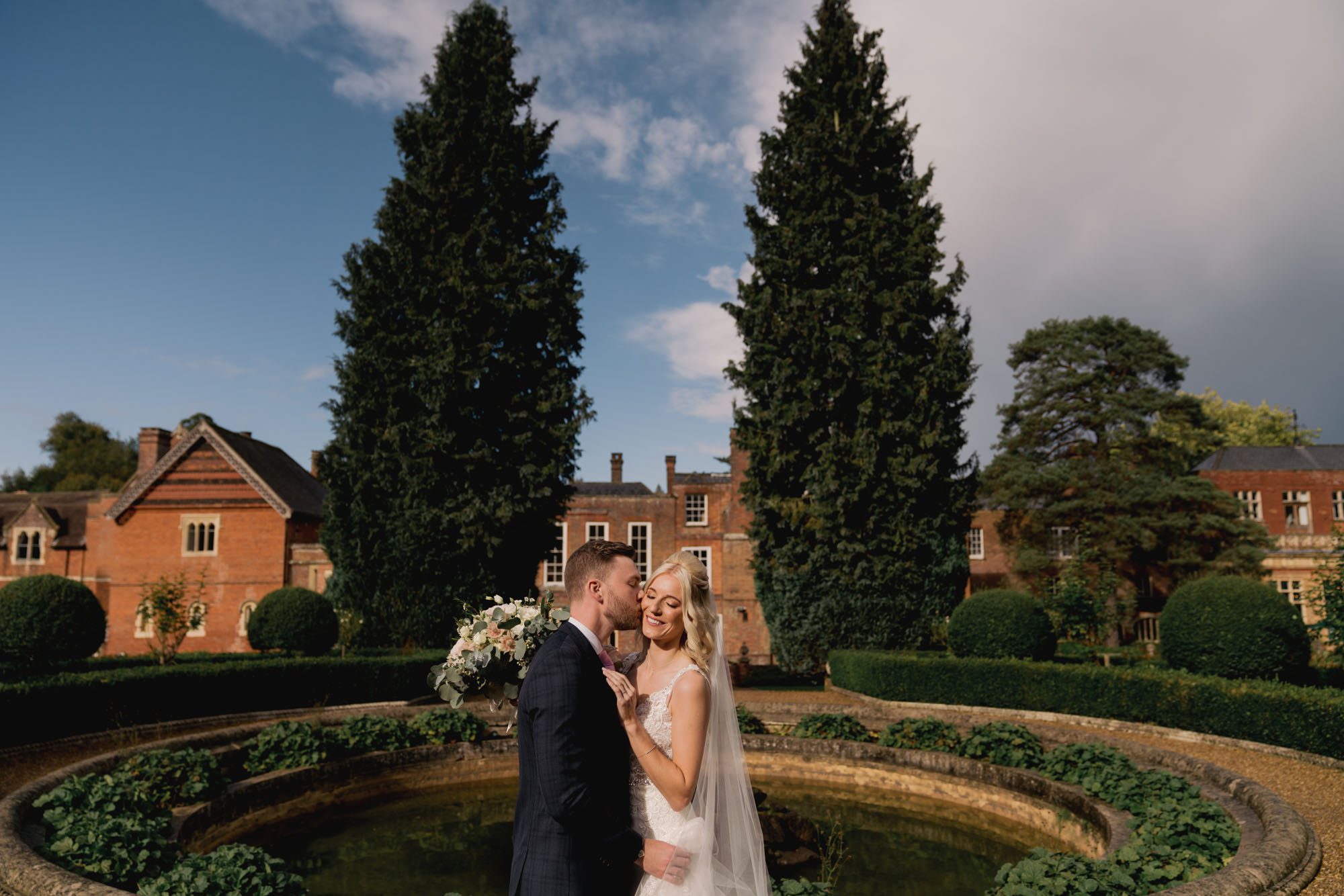Bride and groom kiss on their wedding day at Wotton House.