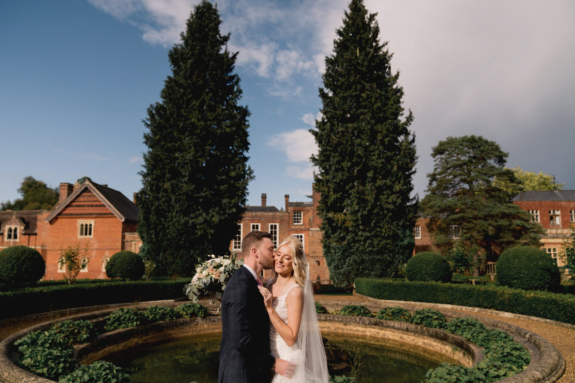 Bride and groom kiss on their wedding day at Wotton House in Surrey.