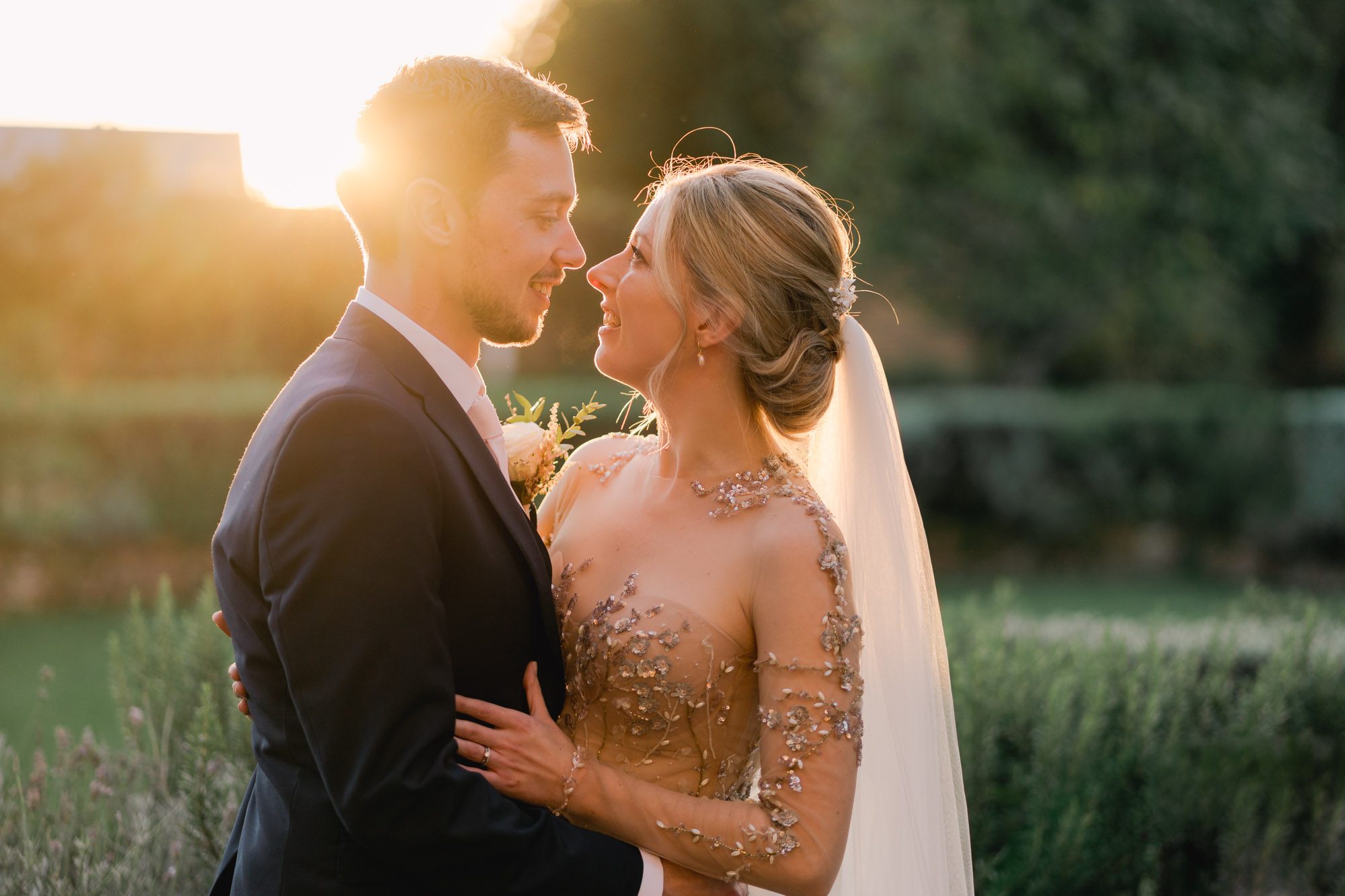 Bride and groom stare lovingly in to each other's eyes during the golden hour at Northbrook Park.