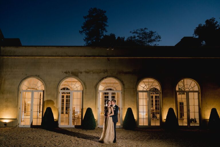 Bride and groom have a cuddle under the twilight sky at Northbrook Park.
