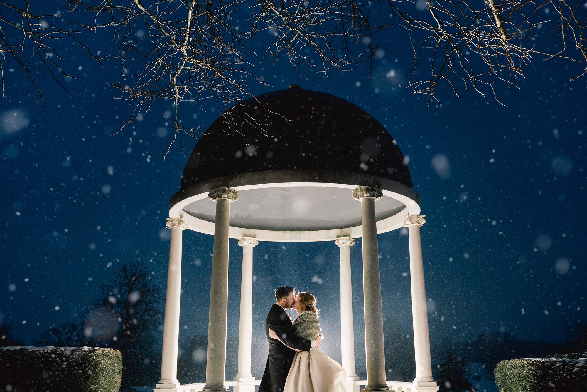 Bride and groom kiss on their wedding day in the snow in Chelmsford.